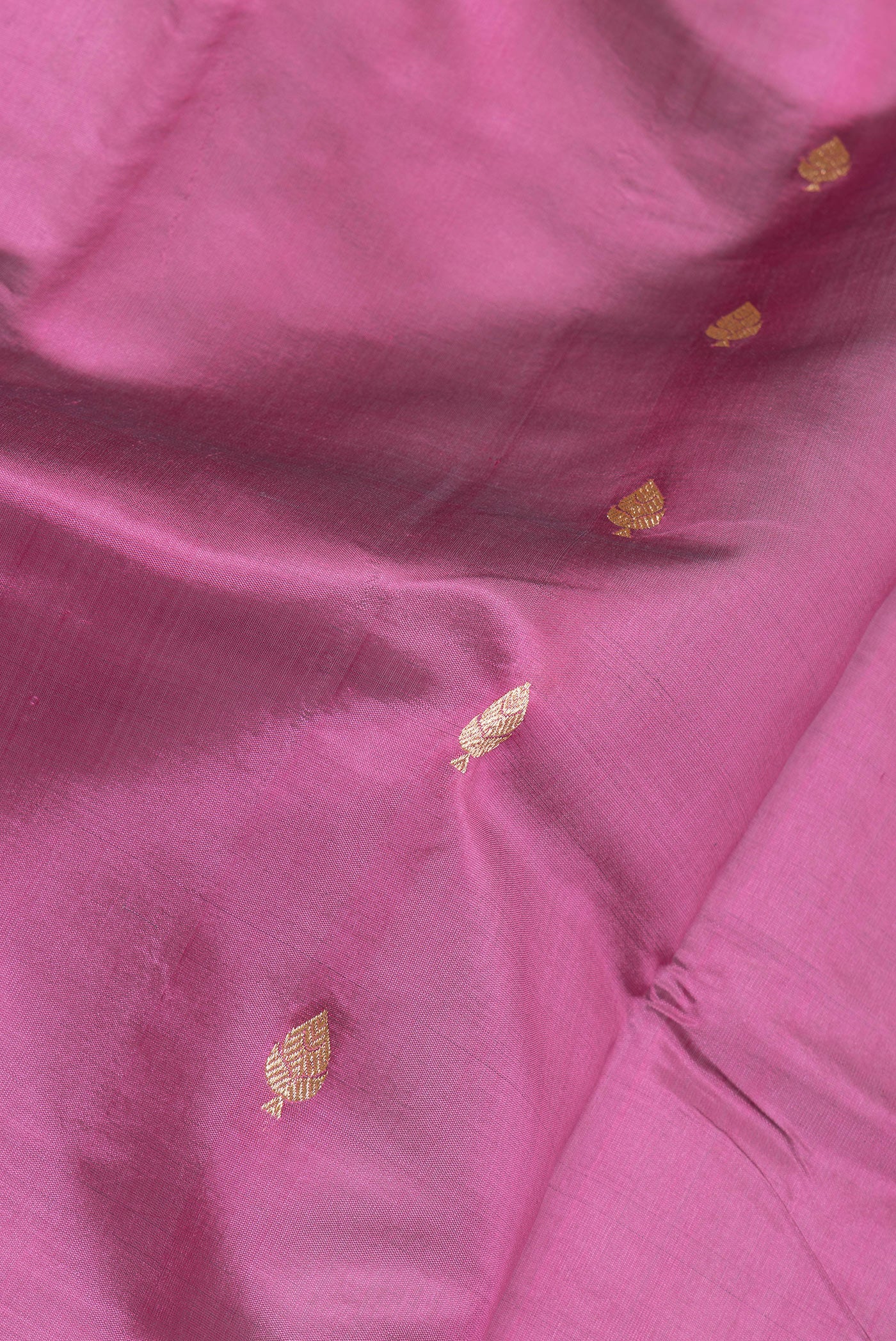 Close up of Light Magenta Banarasi Silk Saree with Zari Butta on the body and Zari Border.  displaying folds