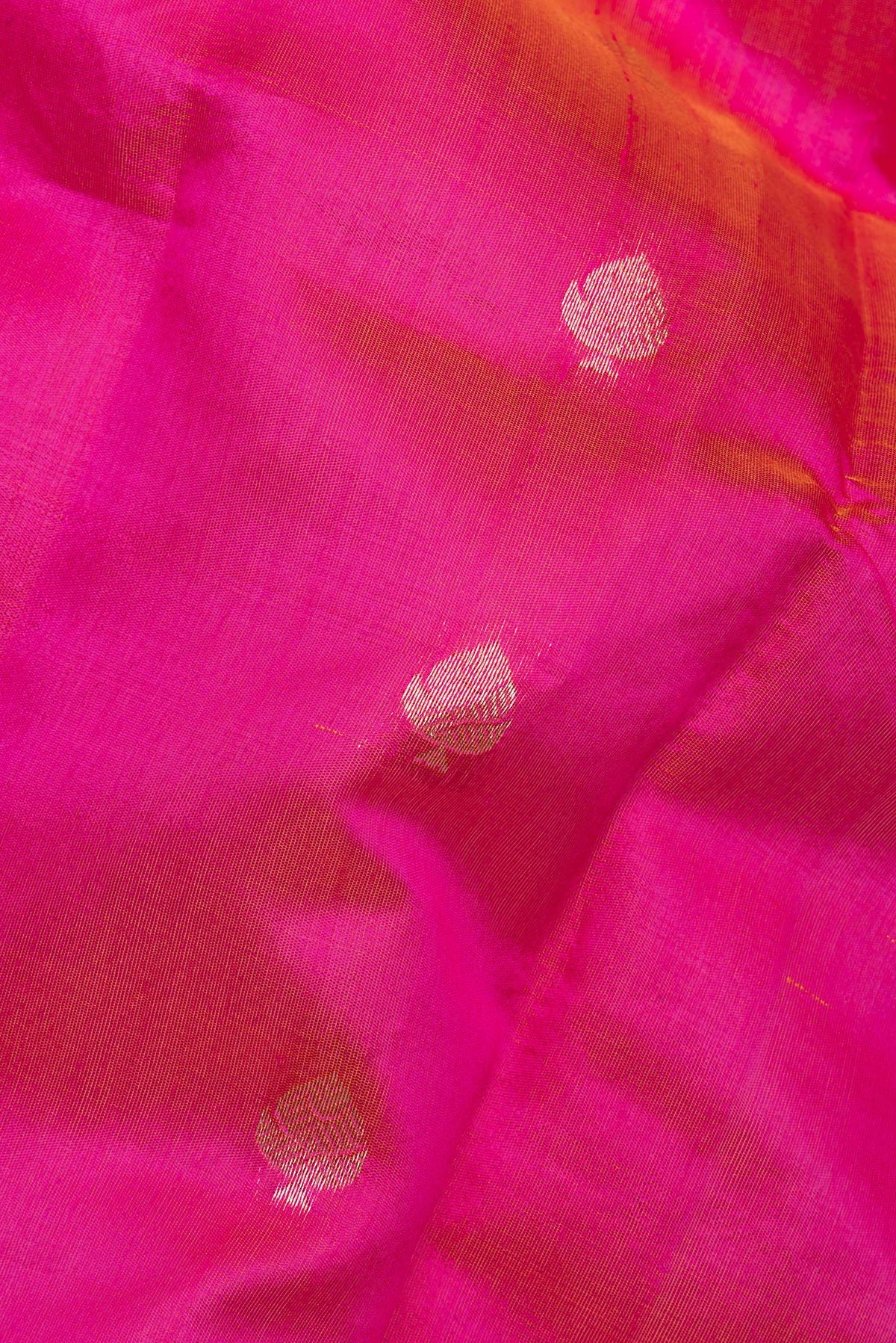 Close up of Pure Silk Pink Banarasi Saree with Zari Butta on the body and Zari Border.  displaying folds