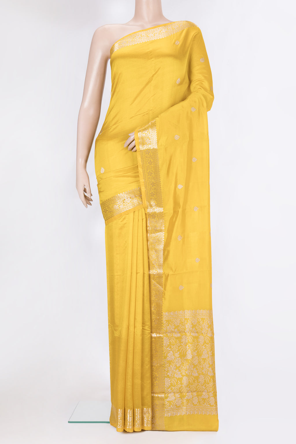 Yellow Banarasi Silk Saree with Zari Butta on the body and Zari Border.  displayed on a mannequin