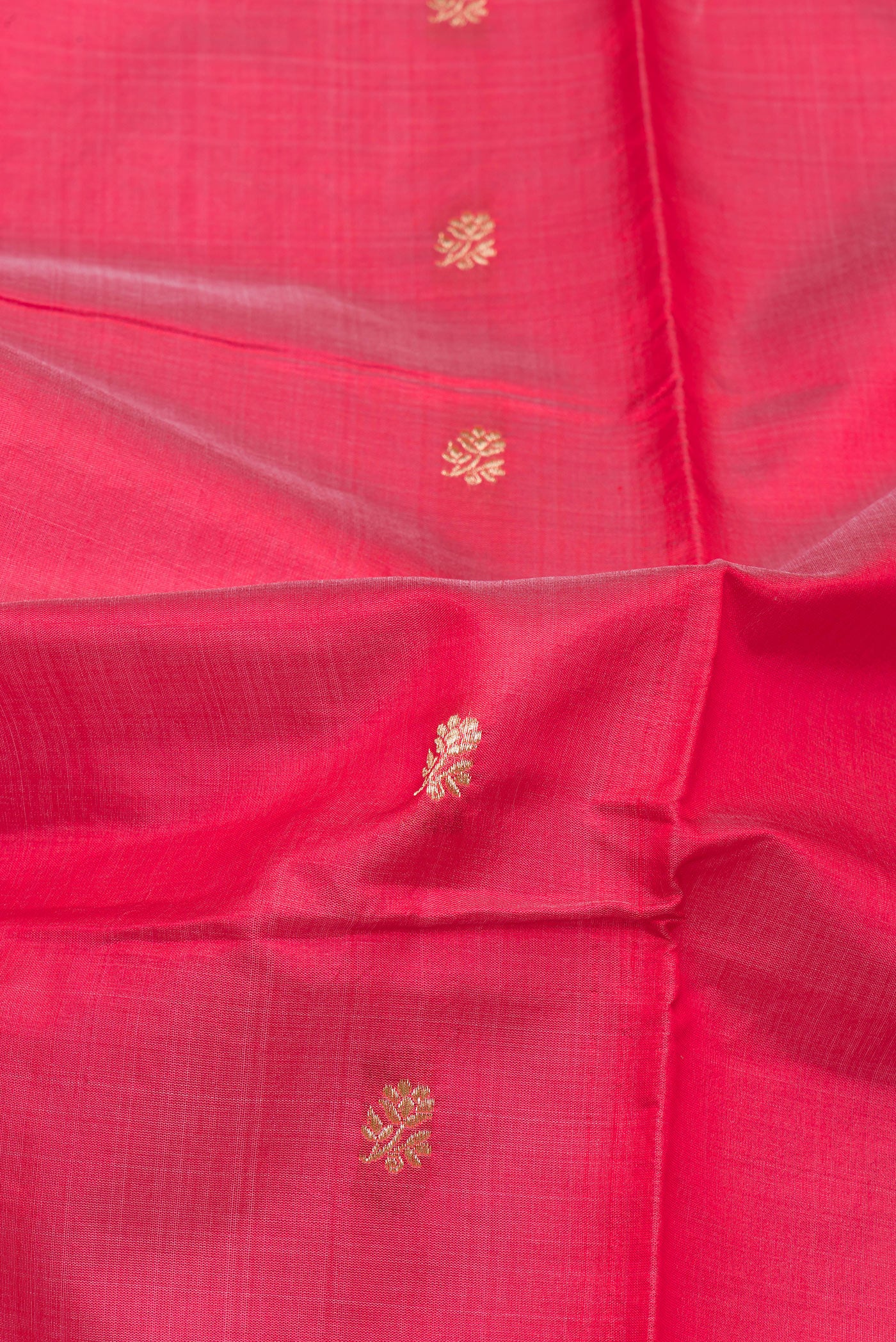 Close up of Pink Banarasi Silk Saree with Zari Butta on the body and Zari Border.  displaying folds