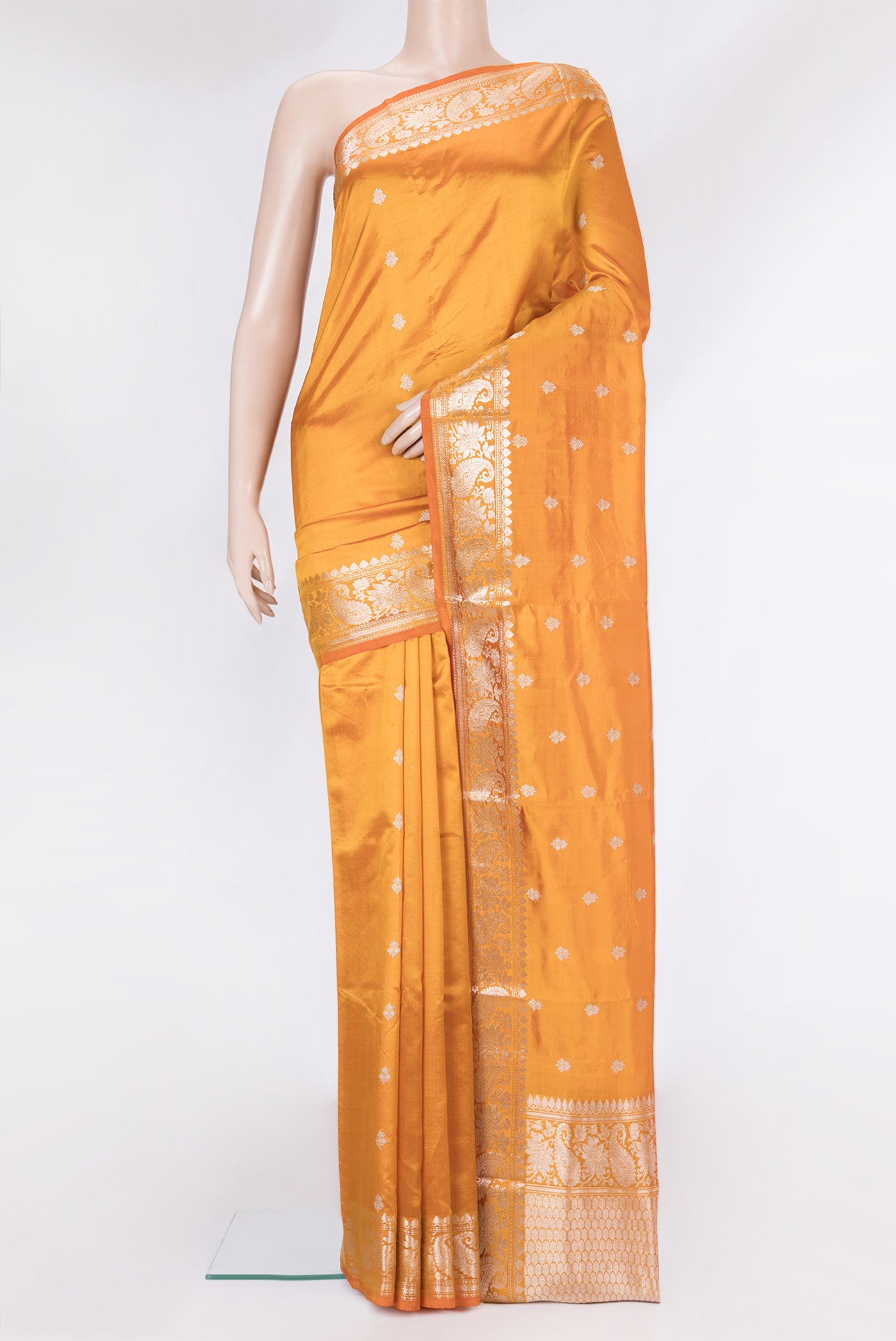 Orange Banarasi Silk Saree with Zari Butta on the body and Zari Border.  displayed on a mannequin