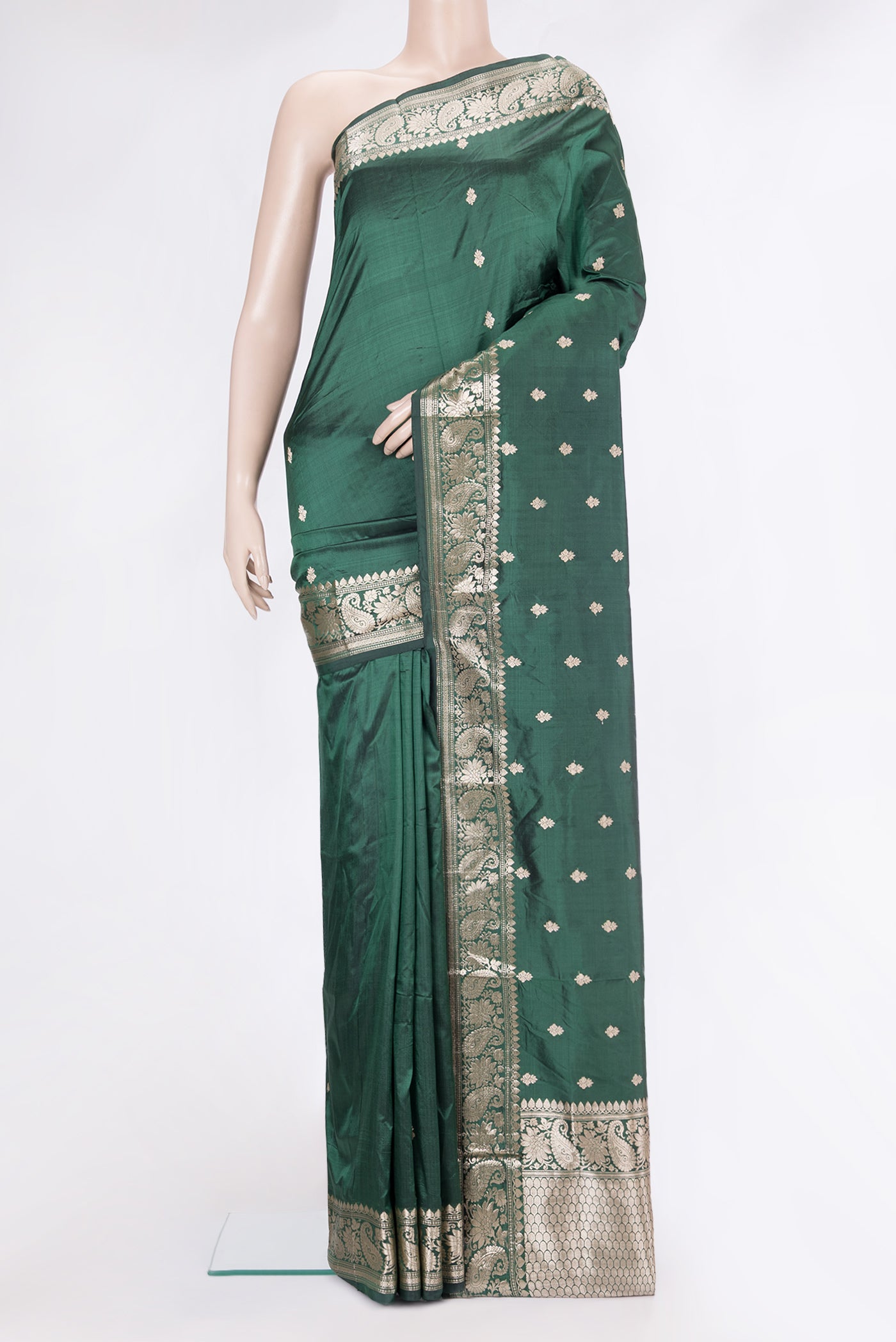 Bottle Green Banarasi Silk Saree with Zari Butta on the body and Zari Border.  displayed on a mannequin