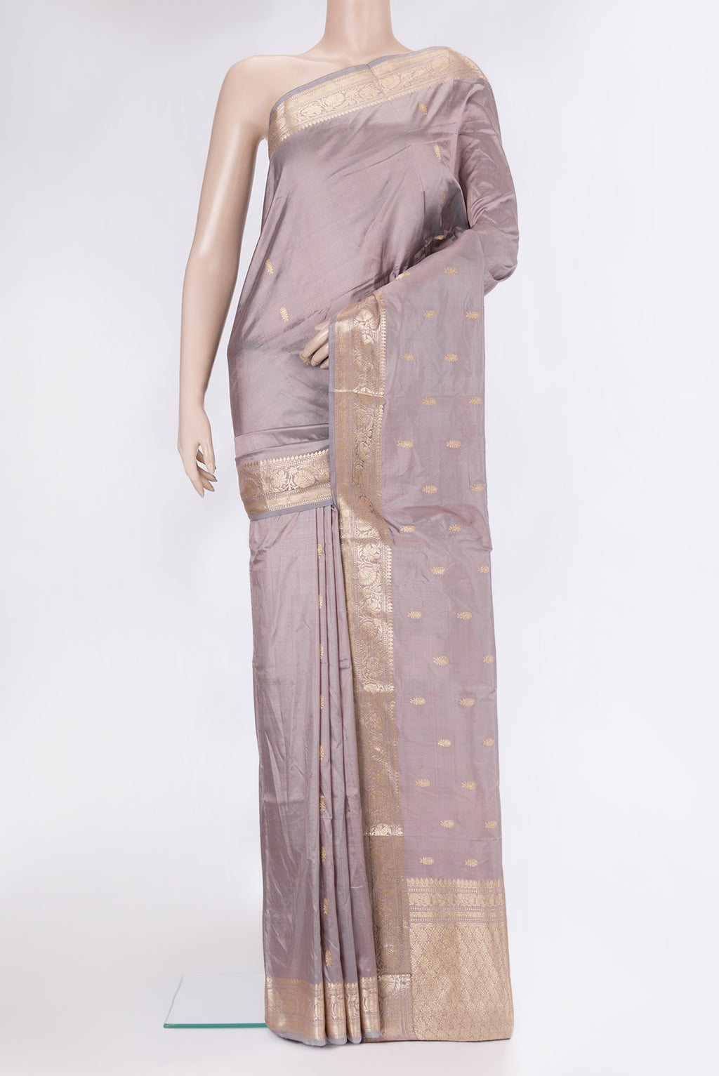 Lilac Banarasi Silk Saree with Zari Butta on the body and Zari Border.  displayed on a mannequin