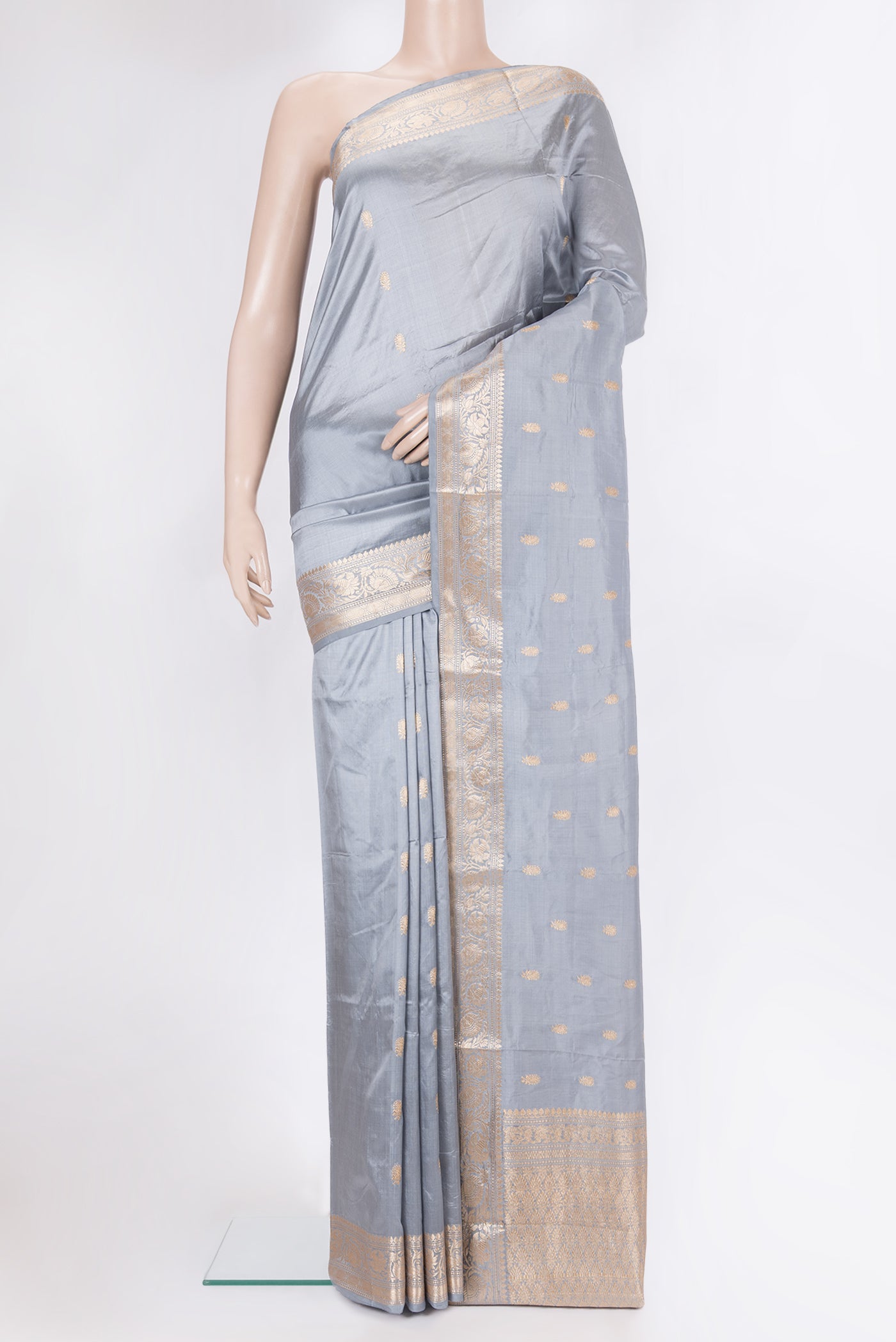 Grey Banarasi Silk Saree with Zari Butta on the body and Zari Border.  displayed on a mannequin