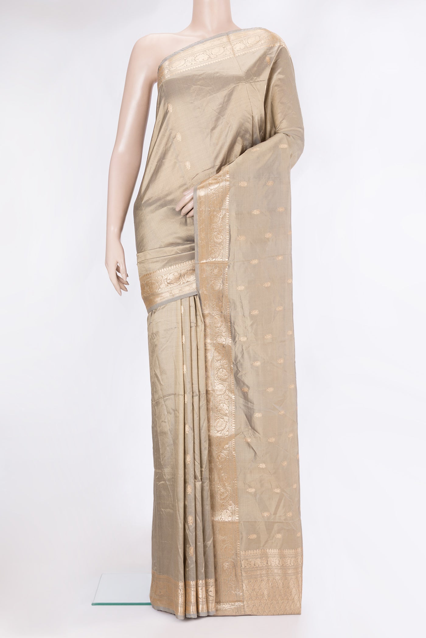Beige Dual Tone Banarasi Silk Saree with Zari Butta on the body and Zari Border.  displayed on a mannequin