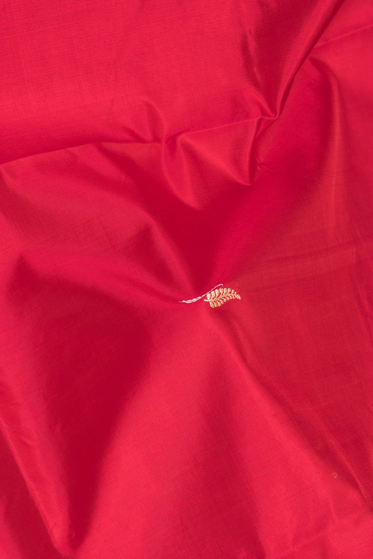 Close up of Red Banarasi Silk Saree with Thread Butta on the body and Thread Border.  displaying folds