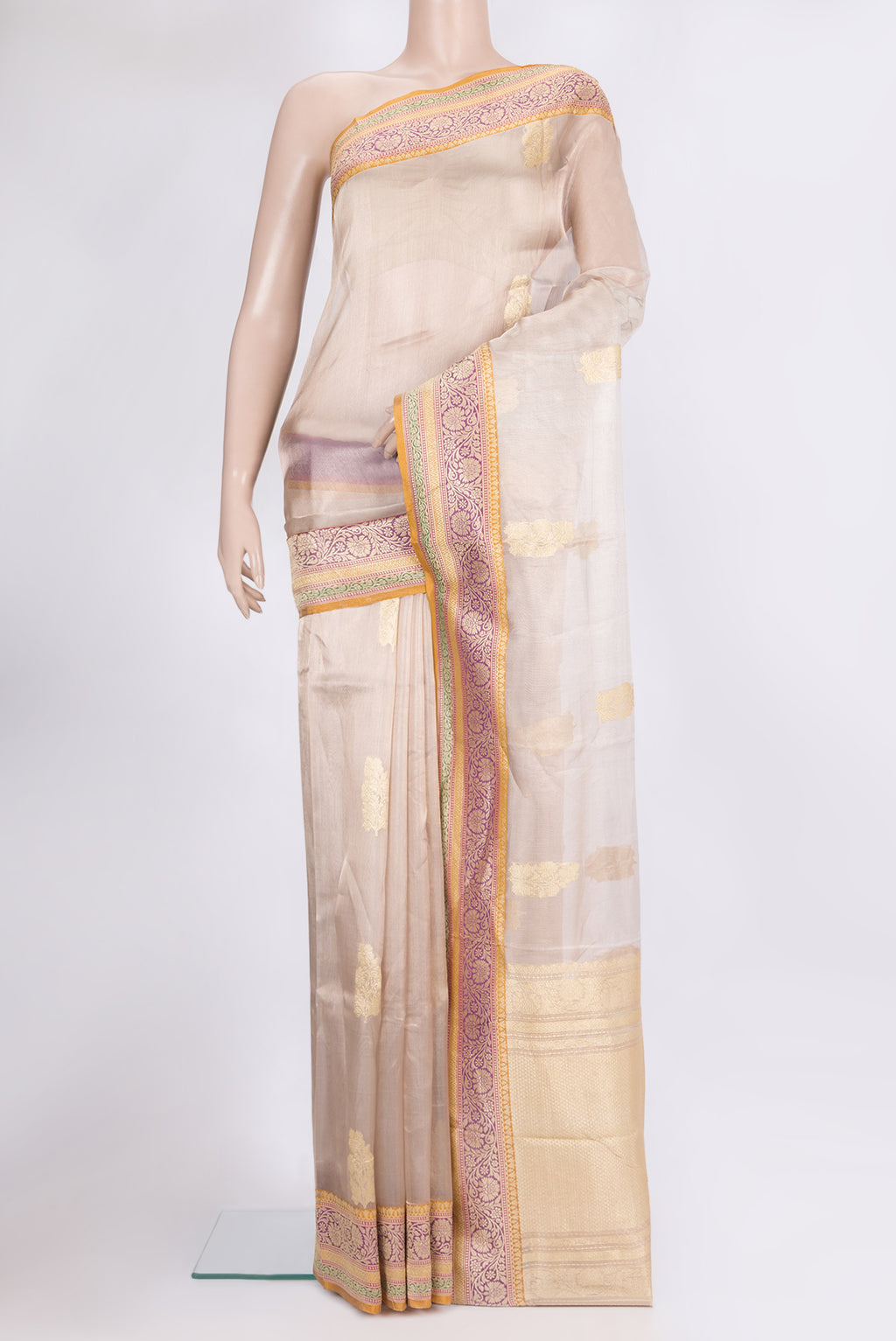 Rose Gold Organza Saree with Zari Butta on the body and Zari Border.  displayed on a mannequin