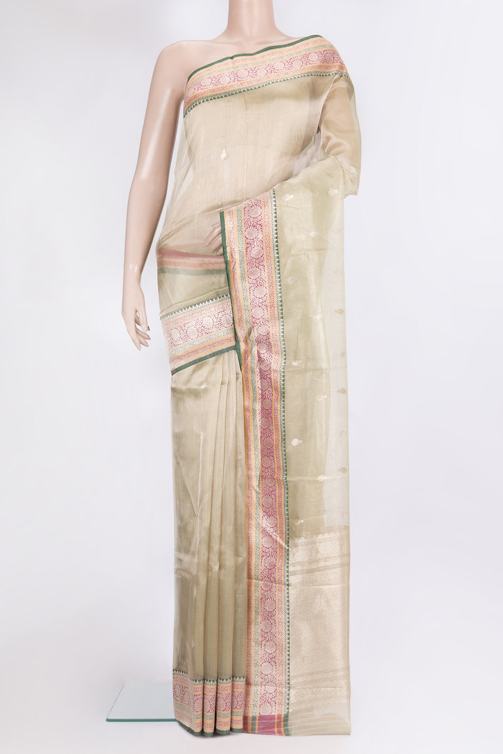Gold Organza Saree with Zari Butta on the body and Zari Border.  displayed on a mannequin