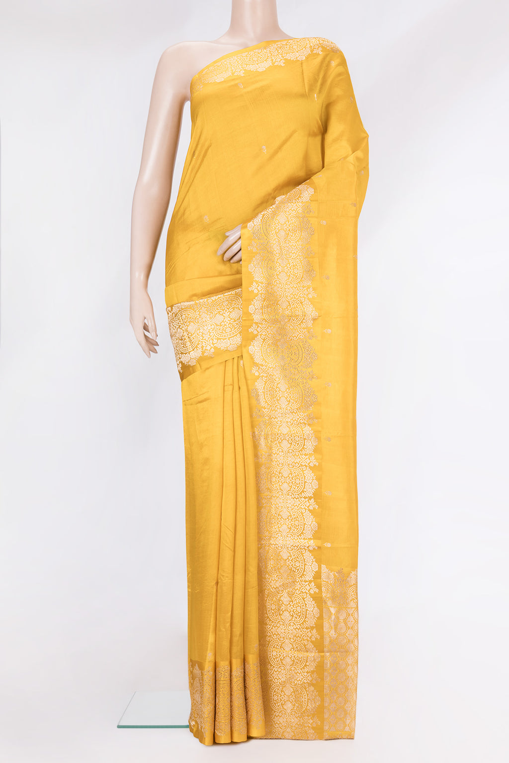 Mustard Banarasi Silk Saree with Zari Butta on the body and Fancy Border.  displayed on a mannequin