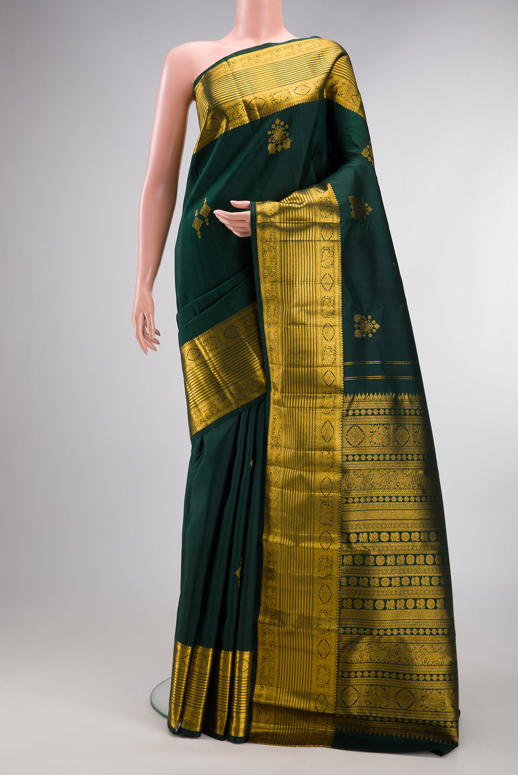 Pure Silk Bottle Green Kanjivaram Saree with Zari Butta on the body and Zari Border.  displayed on a mannequin