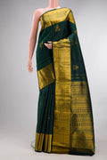 Pure Silk Bottle Green Kanjivaram Saree with Zari Butta on the body and Zari Border.  displayed on a mannequin