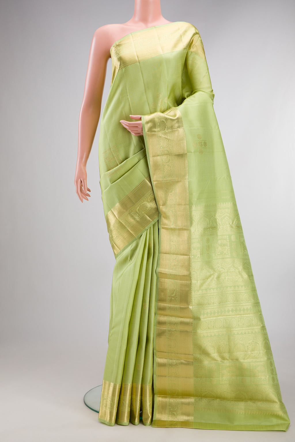 Pure Silk Pista Green Kanjivaram Saree with Zari Butta on the body and Zari Border.  displayed on a mannequin