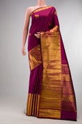 Pure Silk Magenta Kanjivaram Saree with Zari Butta on the body and Zari Border.  displayed on a mannequin