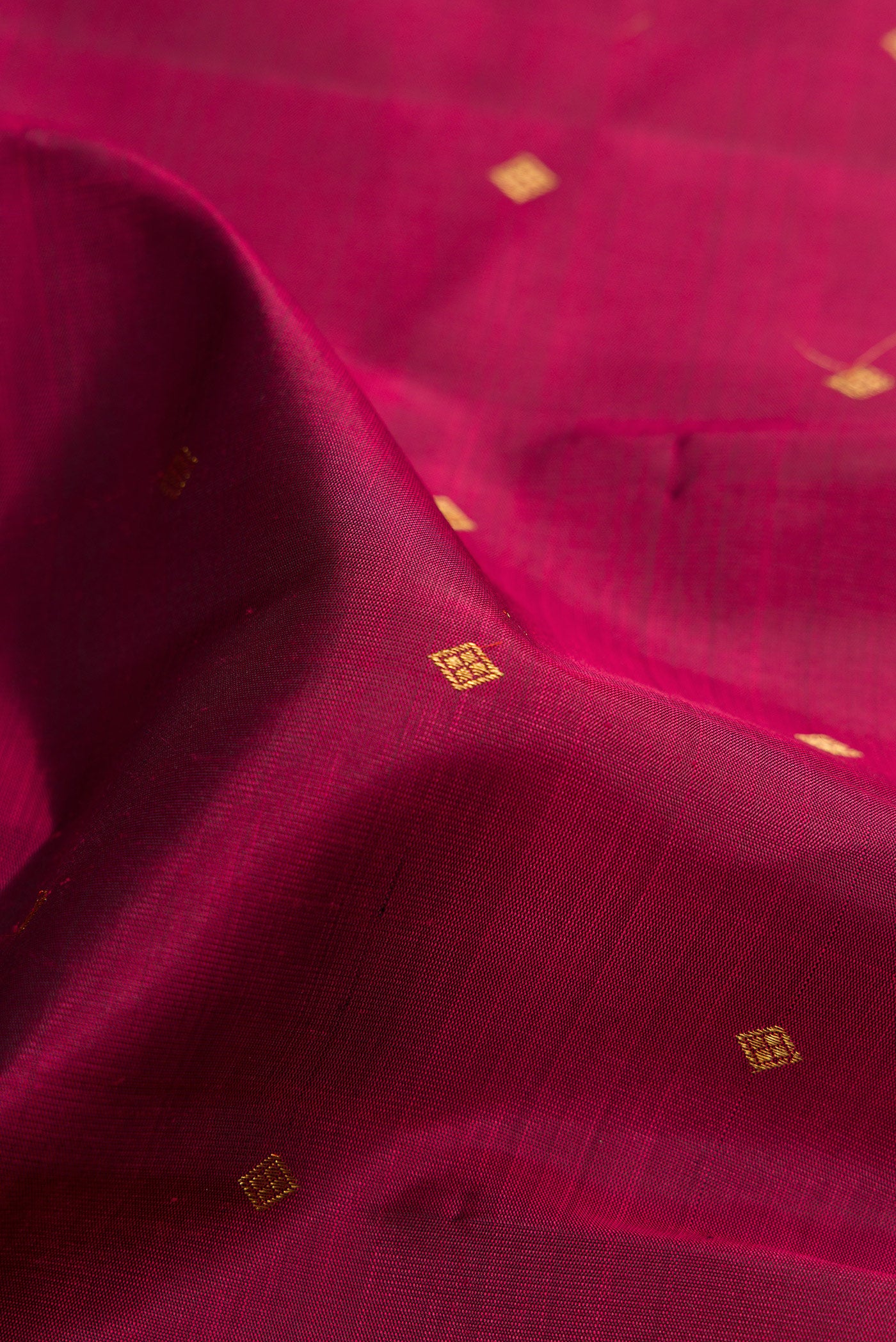 Close up of Pure Silk Pure Zari Maroon Kanchipuram Saree with Zari Butta on the body and Fancy Border.  displaying folds