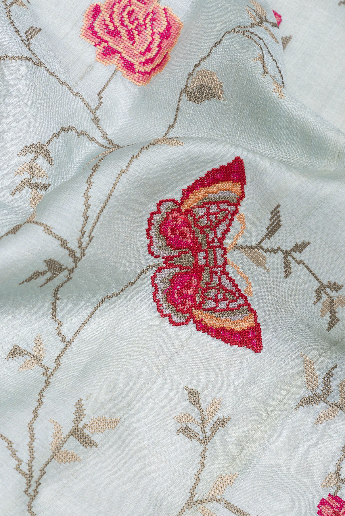 Close up of Light Blue Tussar Saree with Embroidery on the body and Embroidery Border.  displaying folds