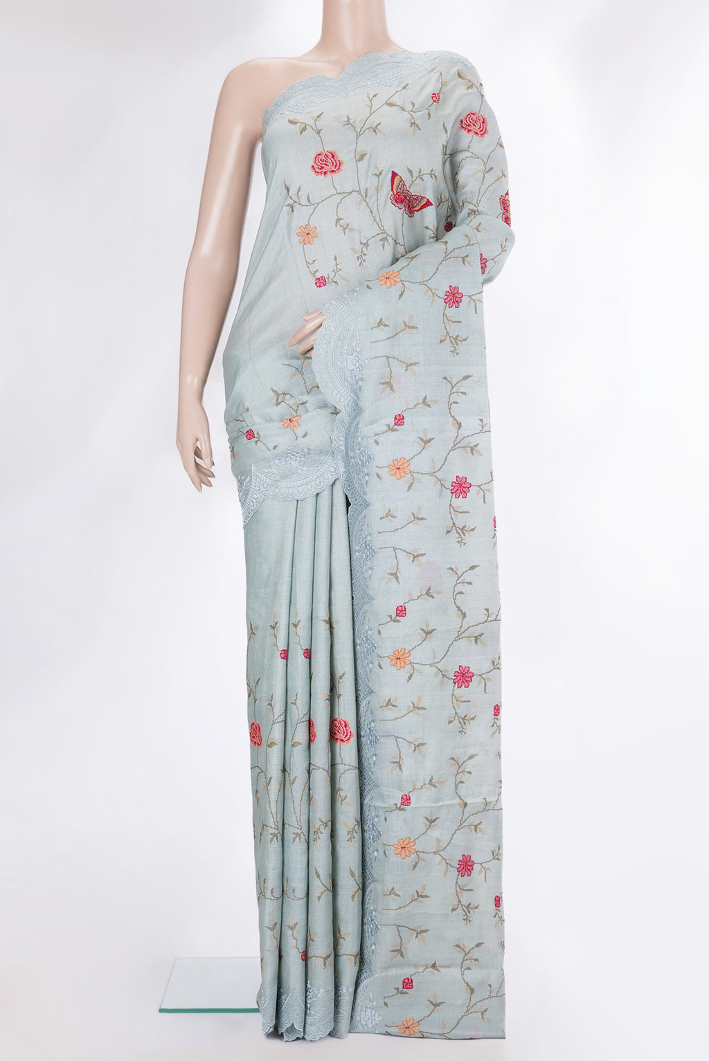 Light Blue Tussar Saree with Embroidery on the body and Embroidery Border.  displayed on a mannequin