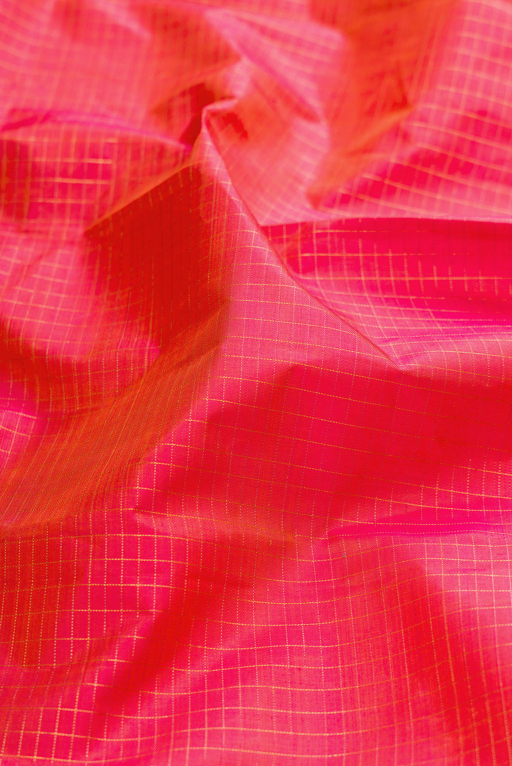 Close up of Pure Silk Coral Dual Tone Kanjivaram Saree with Checked design on the body and Fancy Border.  displaying folds