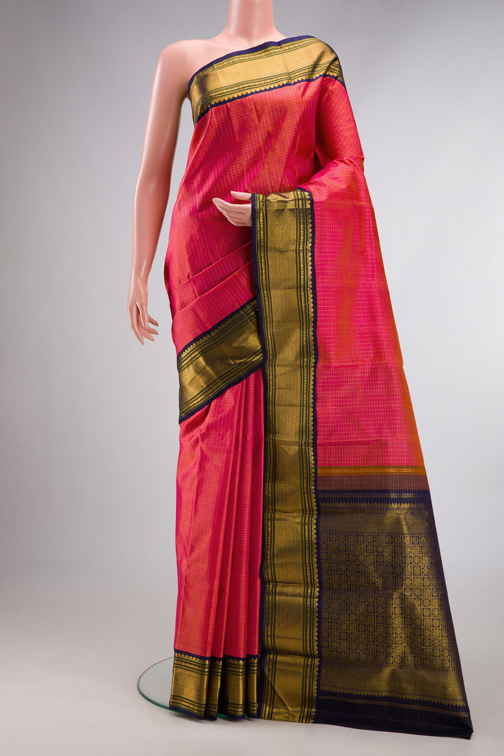 Pure Silk Coral Dual Tone Kanjivaram Saree with Checked design on the body and Fancy Border.  displayed on a mannequin