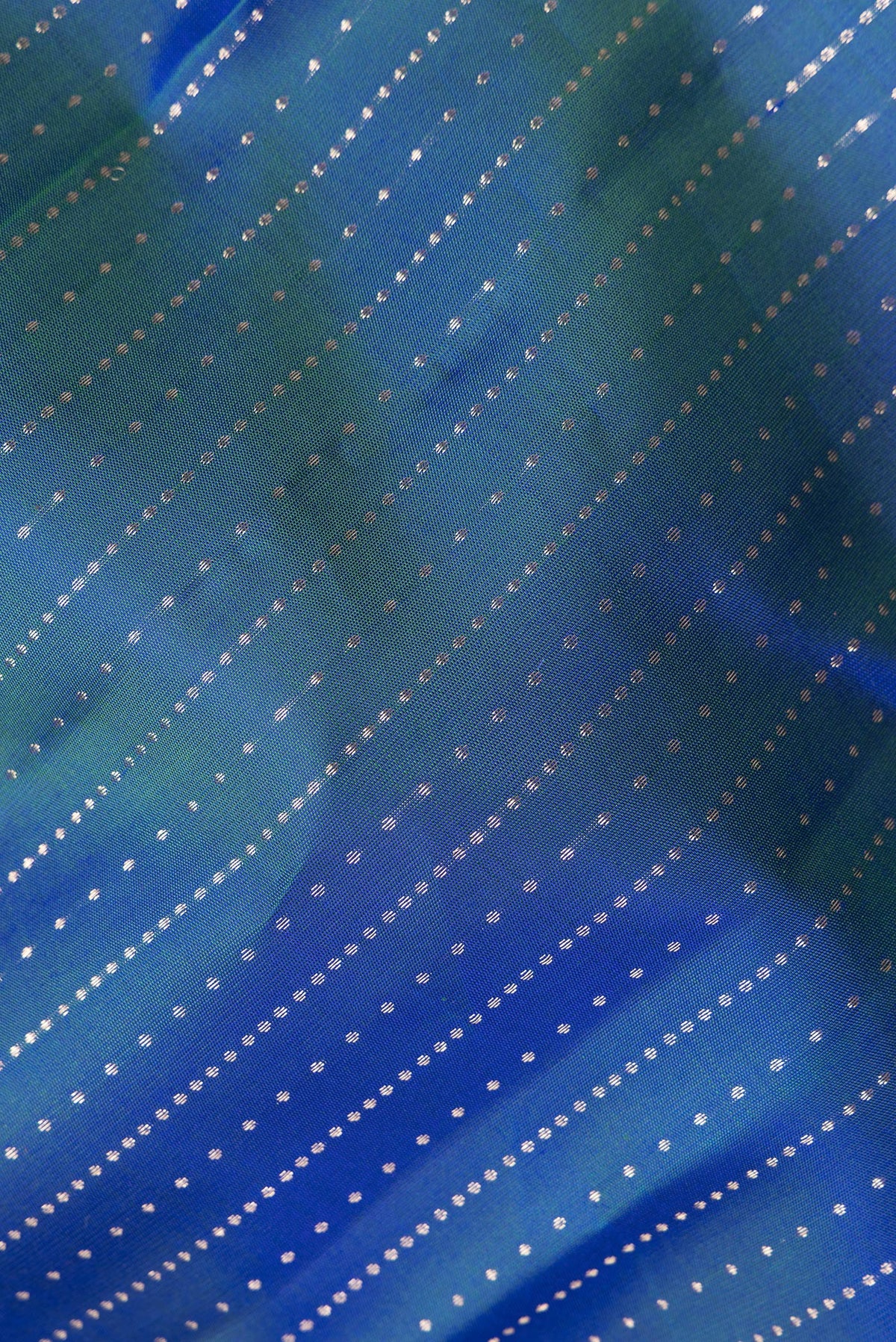 Close up of Pure Silk Peacock Blue Kanchipuram Saree with Stripes on the body and Zari Border.  displaying folds
