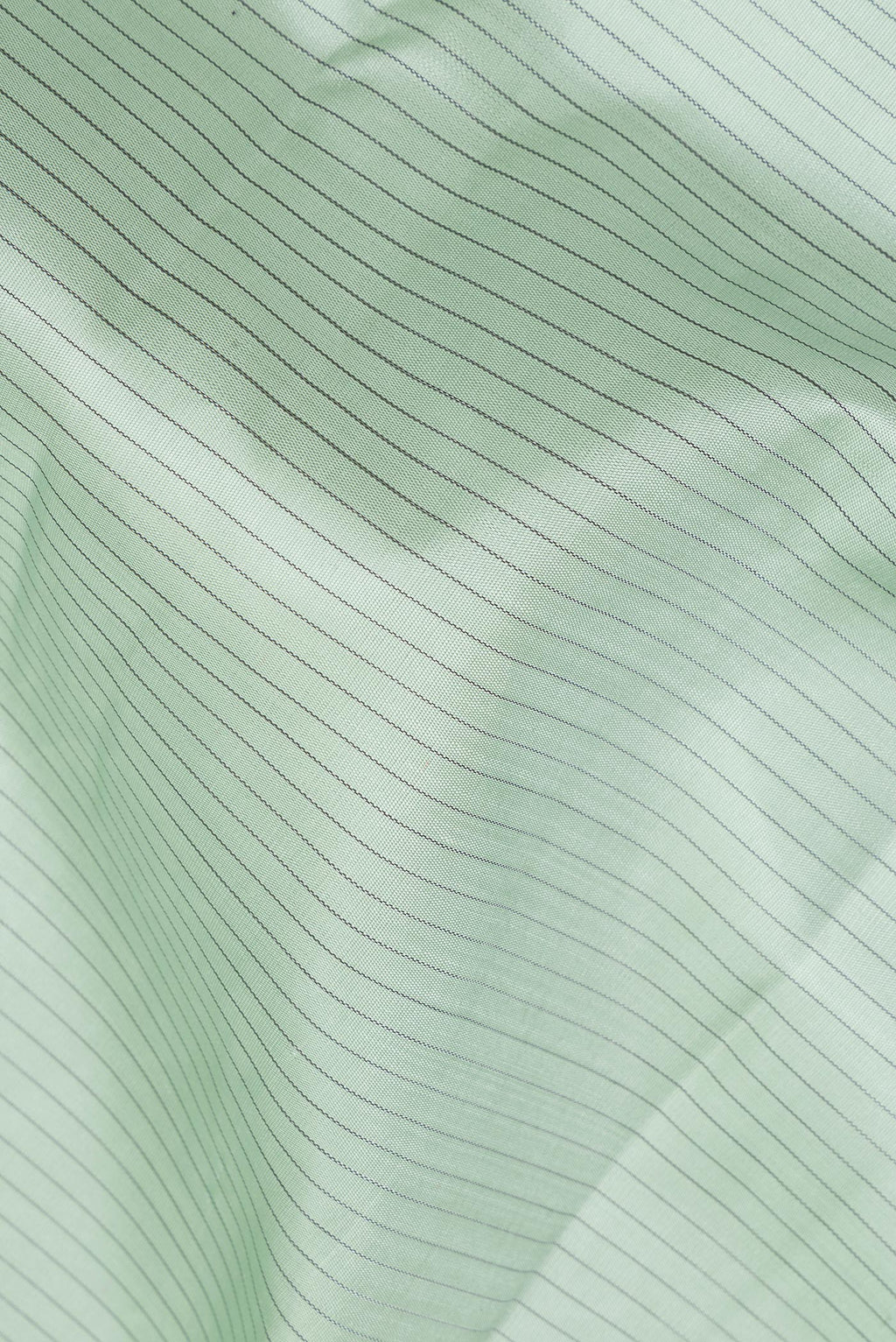 Close up of Pure Silk Light Green Dual Tone Kanchipuram Saree with Stripes on the body and Zari Border.  displaying folds