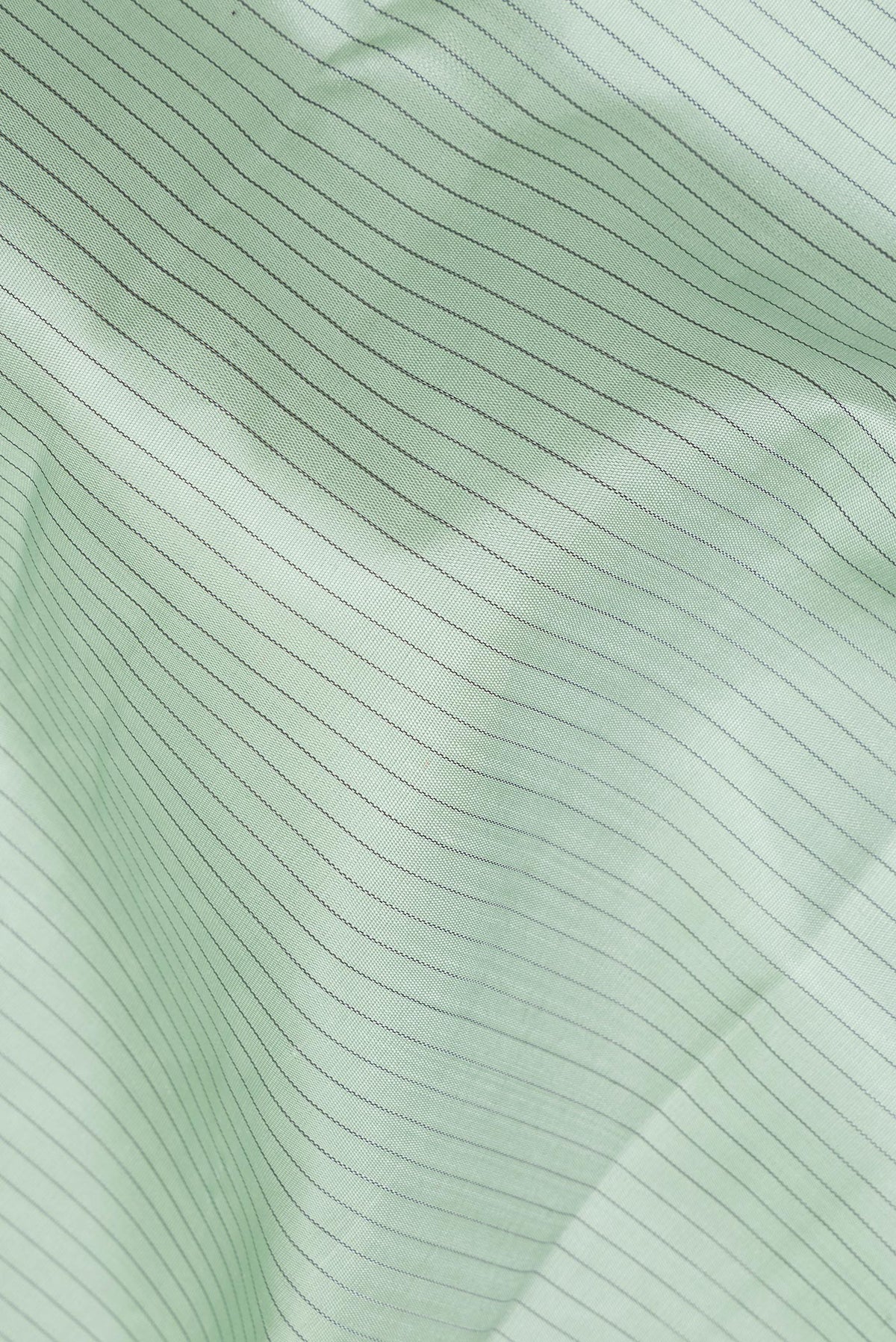 Close up of Pure Silk Light Green Dual Tone Kanchipuram Saree with Stripes on the body and Zari Border.  displaying folds