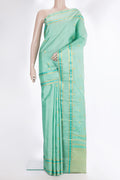 Pure Silk Pista Green Kanchipuram Saree with Zari Butta on the body and Zari And Thread Border.  displayed on a mannequin