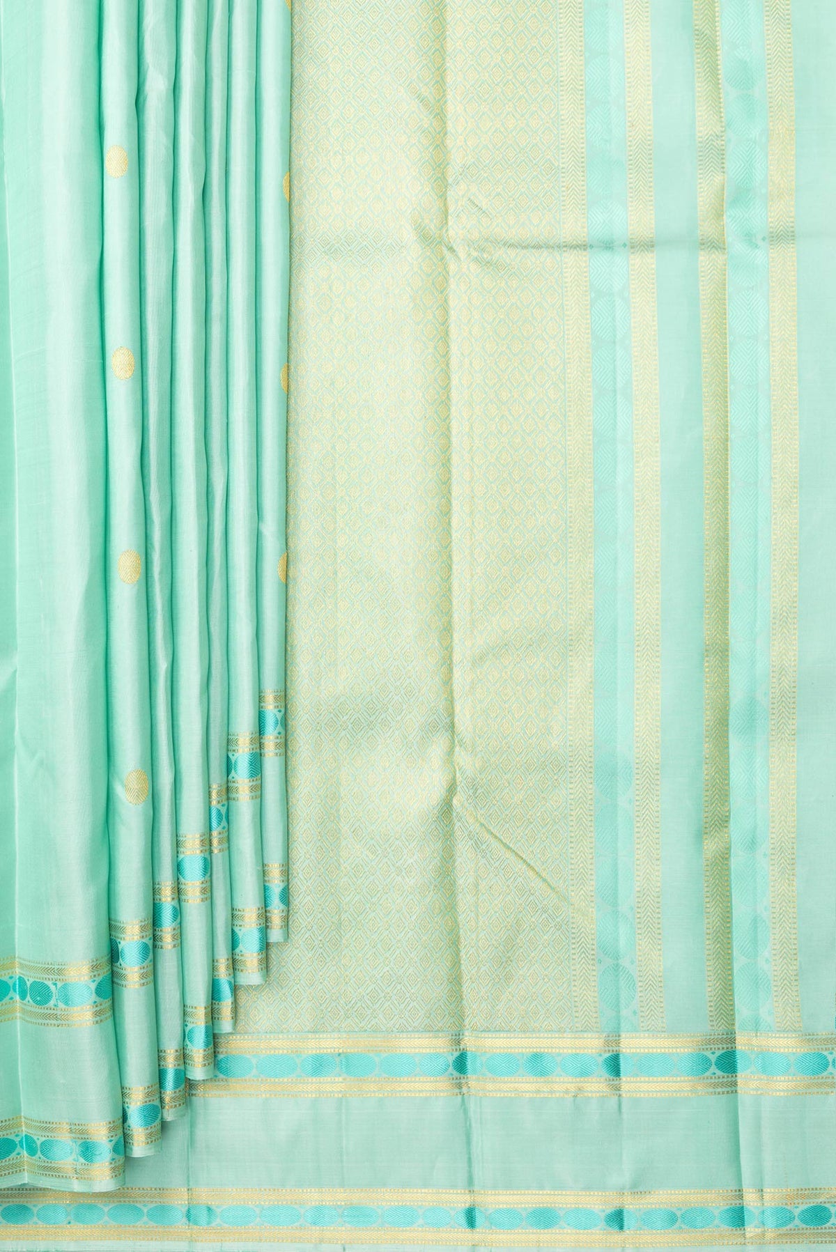Pleats and pallu of Pure Silk Pista Green Kanchipuram Saree with Zari Butta on the body and Zari And Thread Border. 