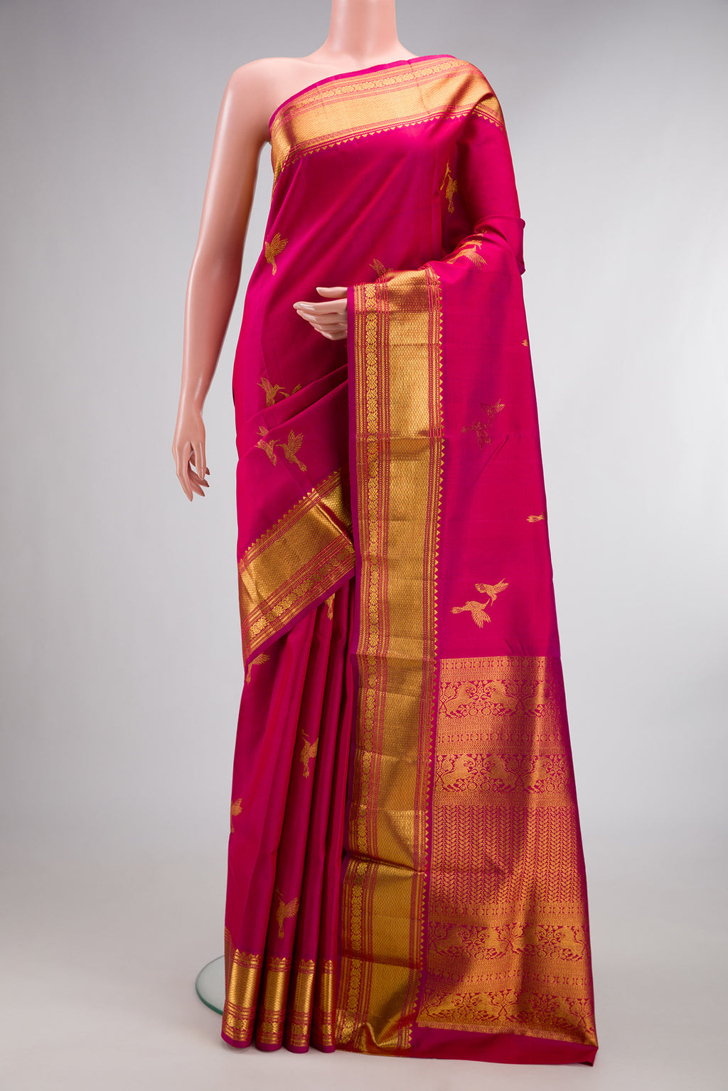 Pure Silk Dark Pink Dual Tone Kanjivaram Saree with Zari Butta on the body and Zari Border.  displayed on a mannequin
