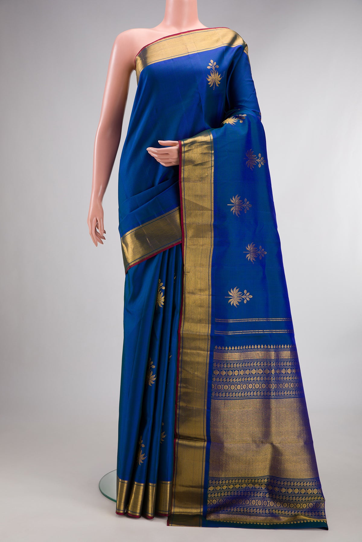 Pure Silk Blue Dual Tone Kanjivaram Saree with Zari Butta on the body and Zari Border.  displayed on a mannequin