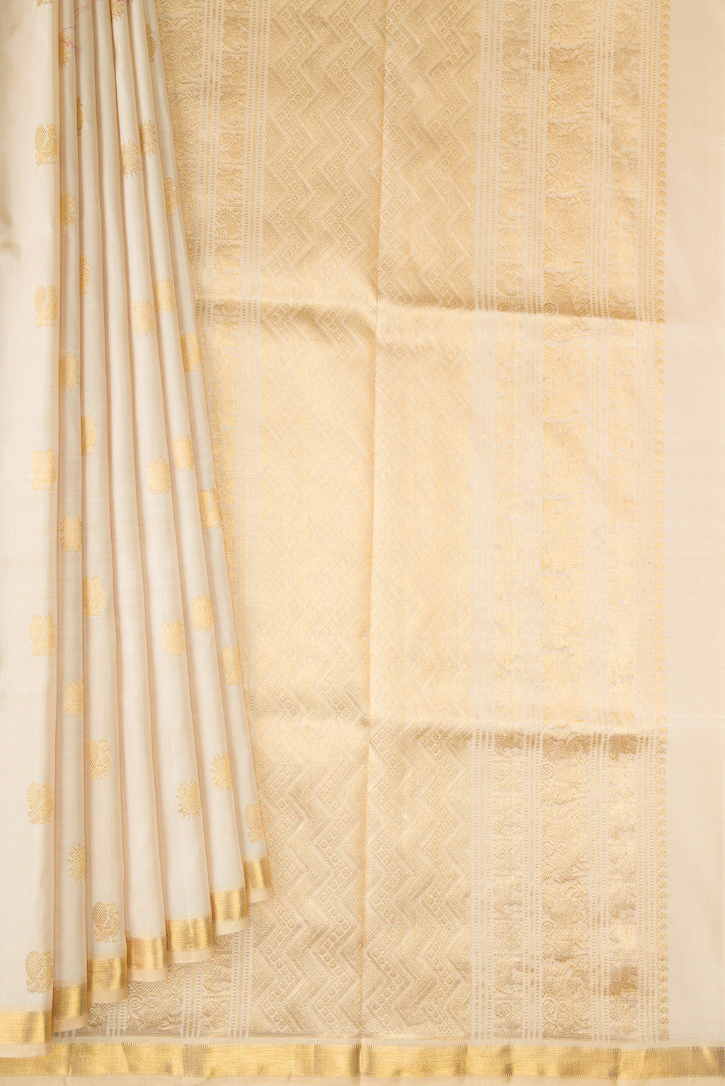 Pleats and pallu of Pure Silk Beige Kanjivaram Saree with Zari Butta on the body and Zari Border. 