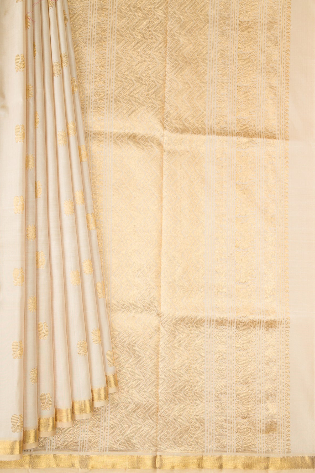 Pleats and pallu of Pure Silk Beige Kanjivaram Saree with Zari Butta on the body and Zari Border. 