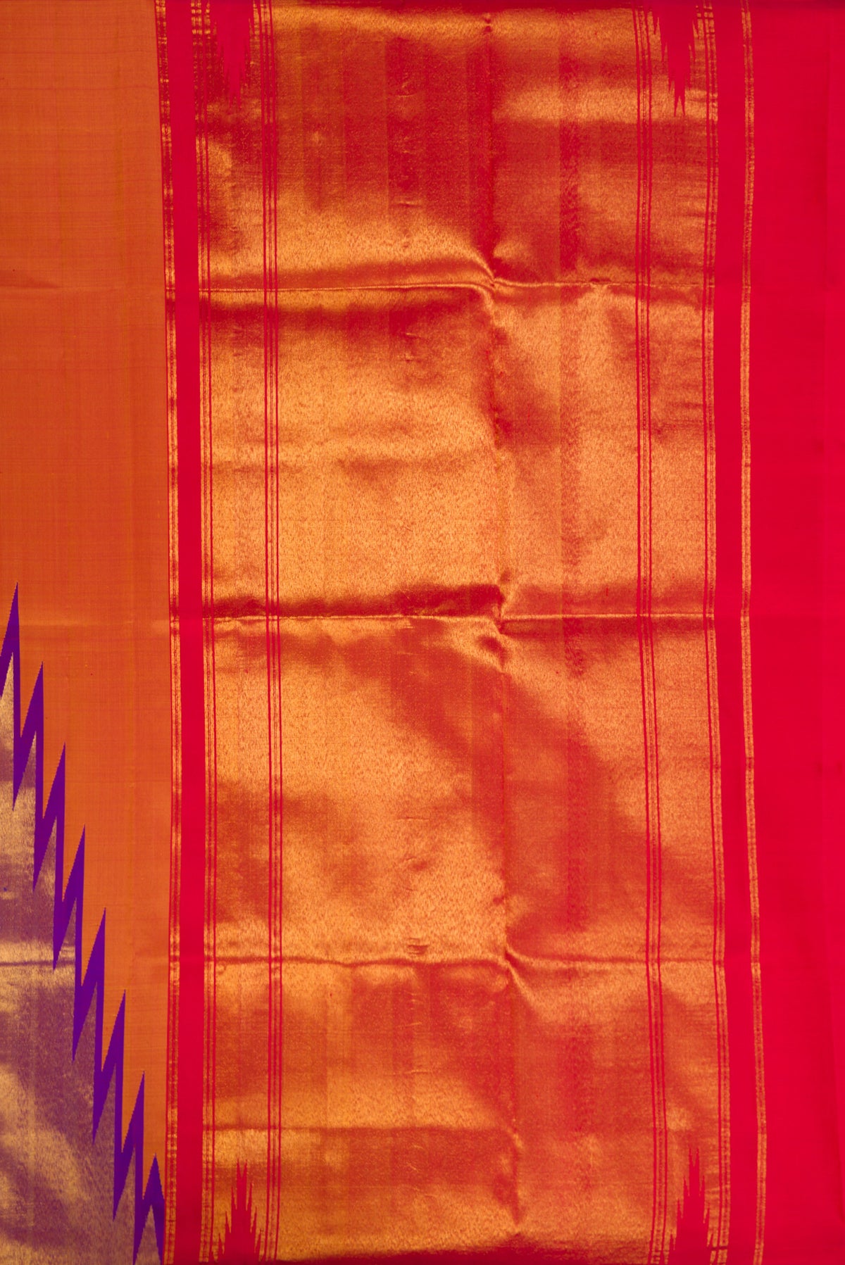 Close up image of the pallu of Pure Silk Brick Orange Dual Tone Kanchipuram Saree with Plain Body and Temple Border. 