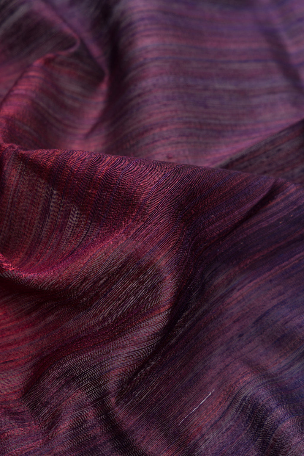 Close up of Multi Color Tussar Saree with Ombre design on the body and Thin Zari Line.  displaying folds
