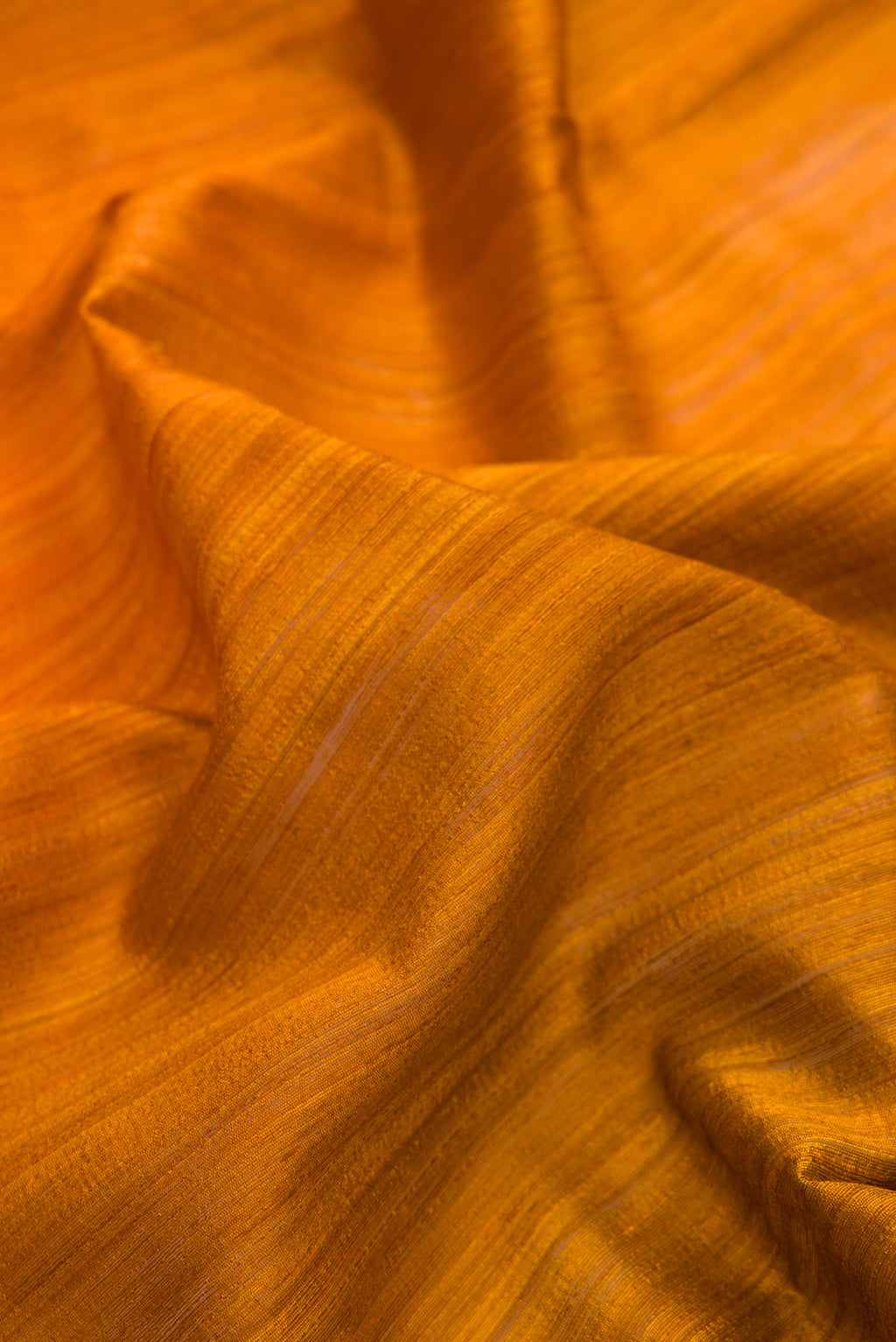 Close up of Multi Color Tussar Saree with Ombre design on the body and Thin Zari Line.  displaying folds