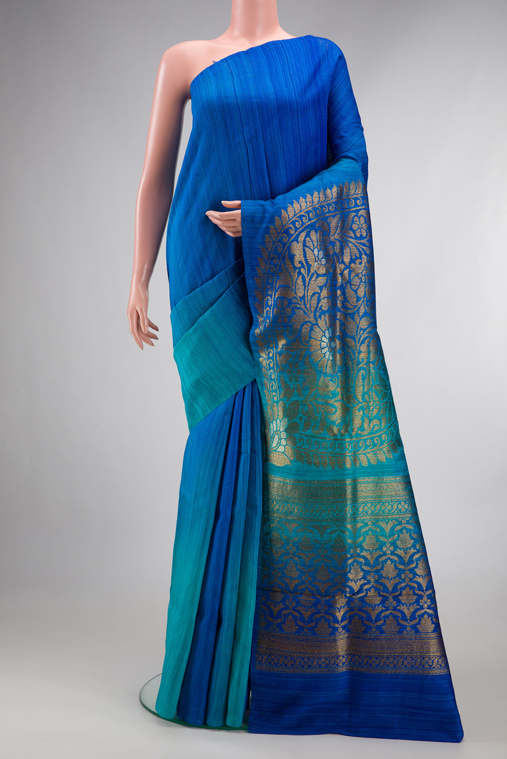 Pure Silk Royal Blue and Sea Green Color Tussar Saree with Ombre design on the body and Without Border.  displayed on a mannequin