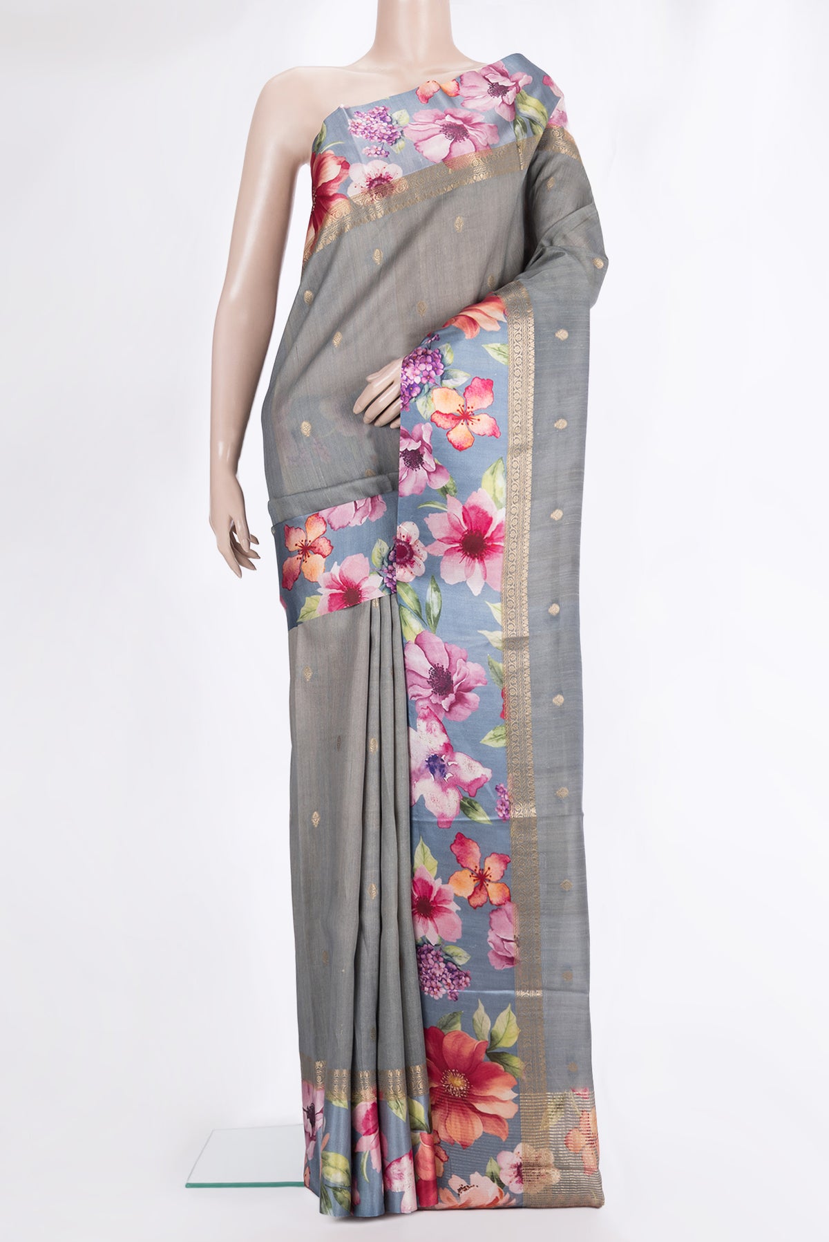 Grey Tussar Saree with Zari Butta on the body and Fancy Border.  displayed on a mannequin
