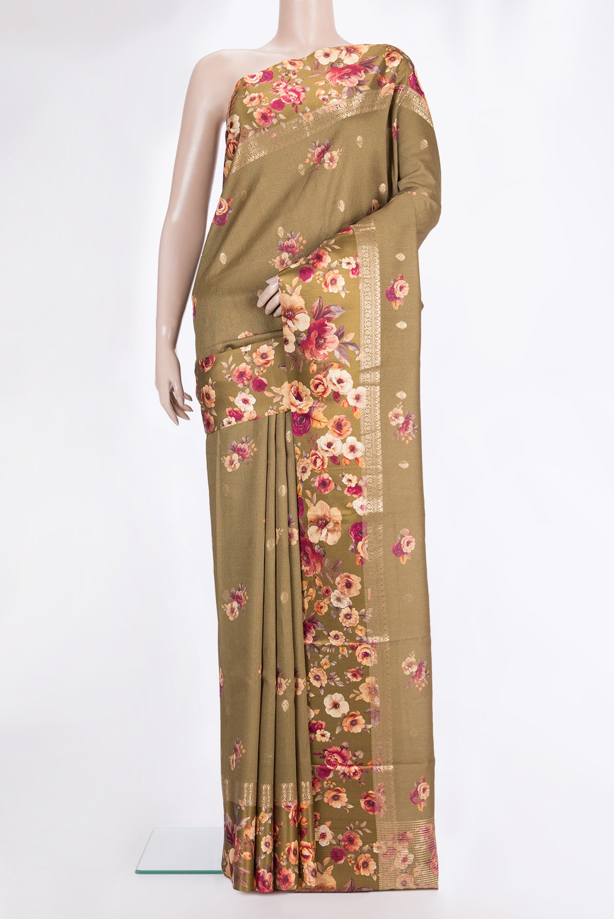 Brown Tussar Saree with Zari Butta on the body and Fancy Border.  displayed on a mannequin