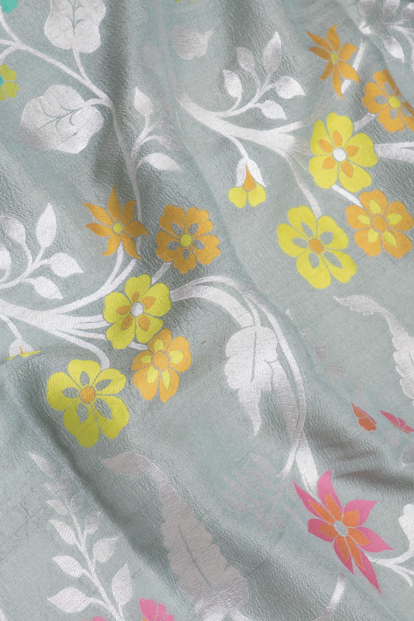 Close up of Grey Tussar Silk Saree with Zari Brocade on the body and Fancy Border.  displaying folds