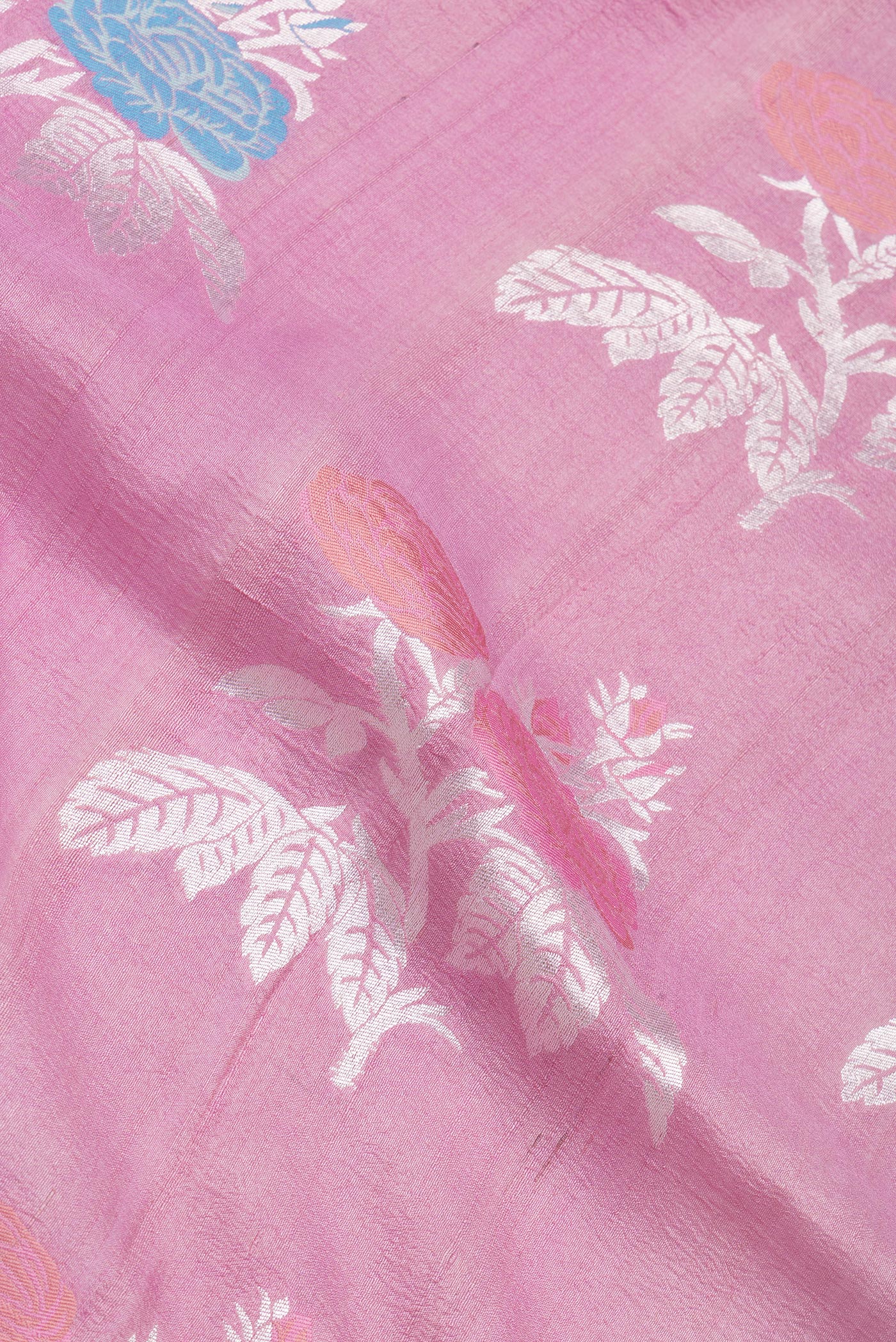 Close up of Pink Tussar Silk Saree with Zari And Thread Butta on the body and Fancy Border.  displaying folds