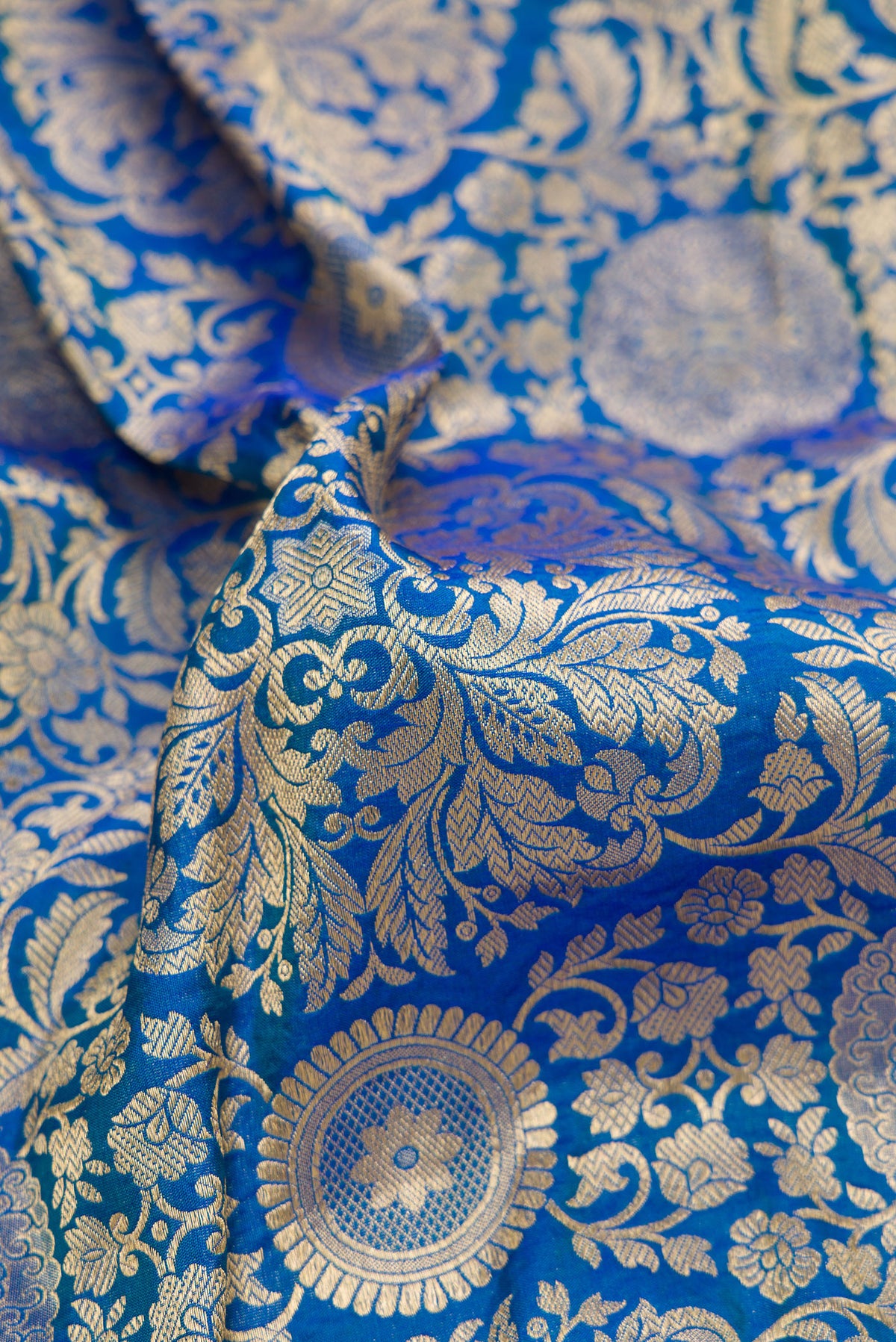 Close up of Pure Silk Royal Blue Dual Tone Banarasi Saree with Zari Brocade on the body and Zari Border.  displaying folds