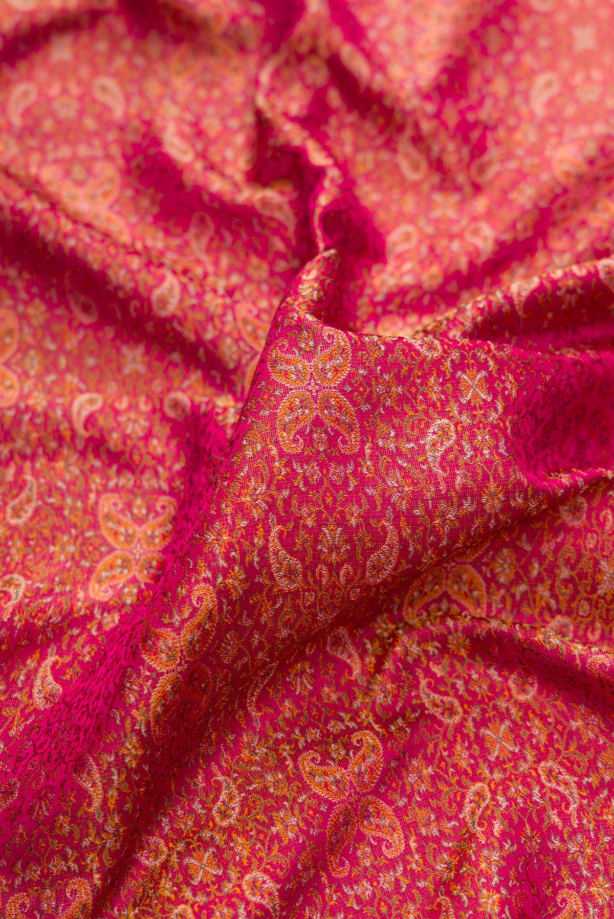 Close up of Pure Silk Dark Pink Dual Tone Banarasi Saree with Jacquard design on the body and Thread Border.  displaying folds