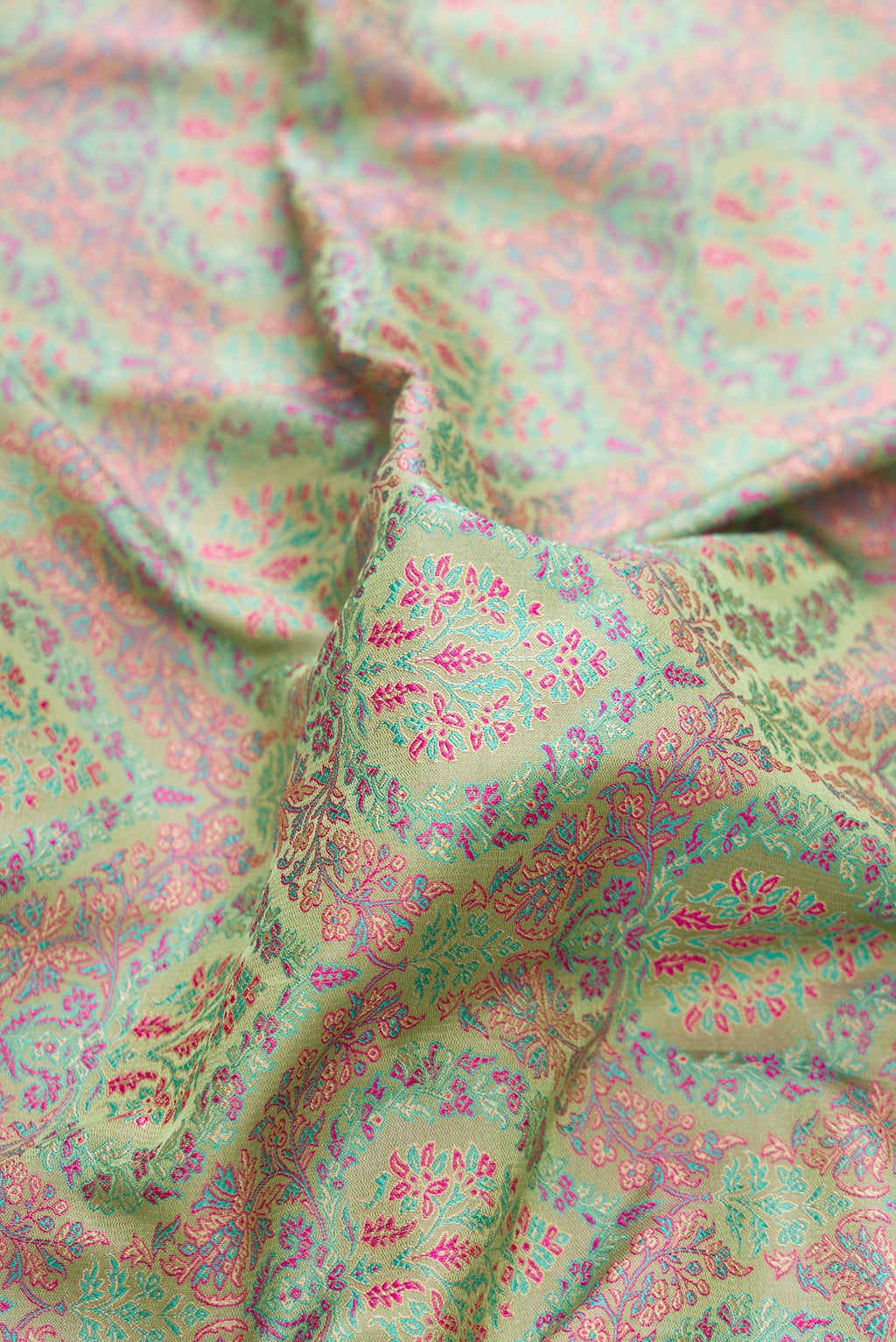 Close up of Pure Silk Pista Green Banarasi Saree with Jacquard design on the body and Thread Border.  displaying folds