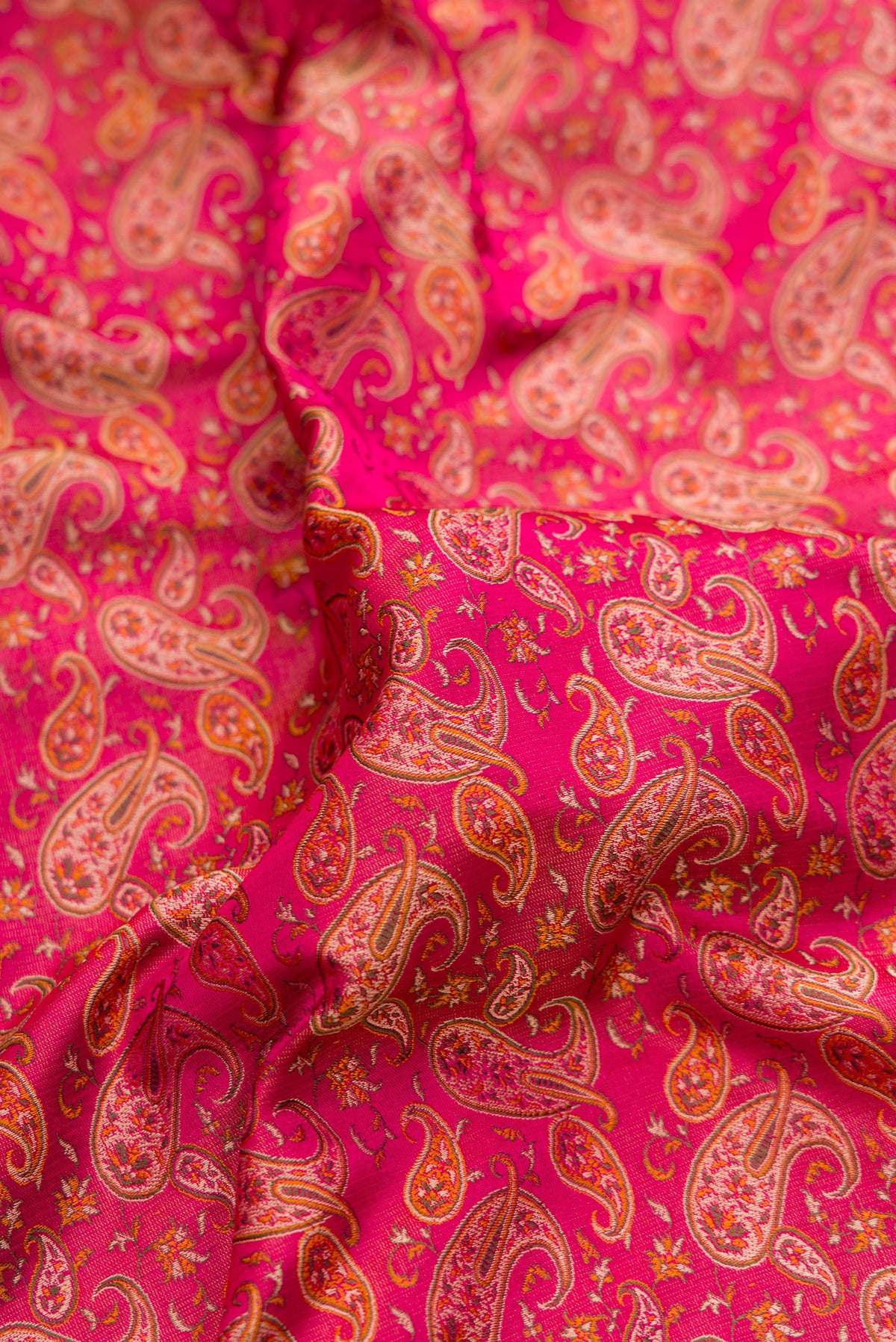 Close up of Pure Silk Dark Pink Dual Tone Banarasi Tanchoi Saree with Jacquard design on the body and Thread Border.  displaying folds