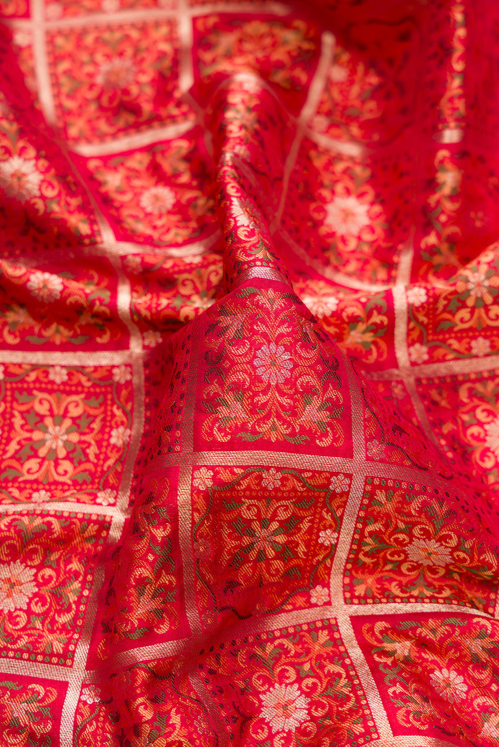 Close up of Pure Silk Red Banarasi Jamavar Saree with Jacquard design on the body and Fancy Border.  displaying folds