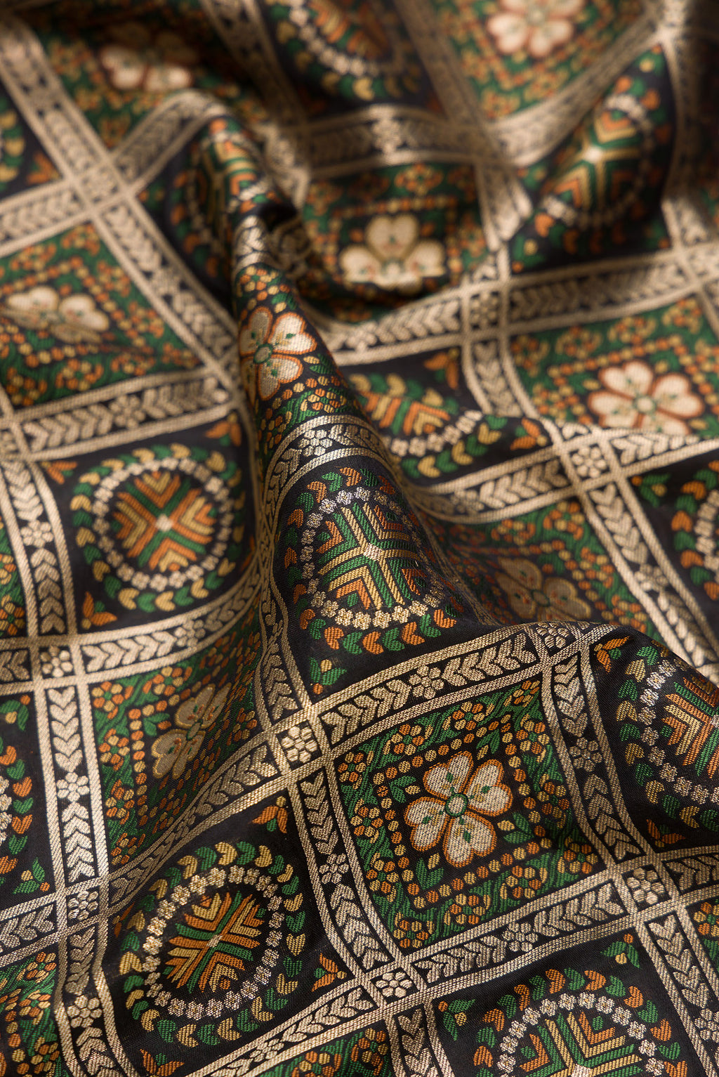 Close up of Pure Silk Black Banarasi Jamavar Saree with Zari Brocade on the body and Fancy Border.  displaying folds