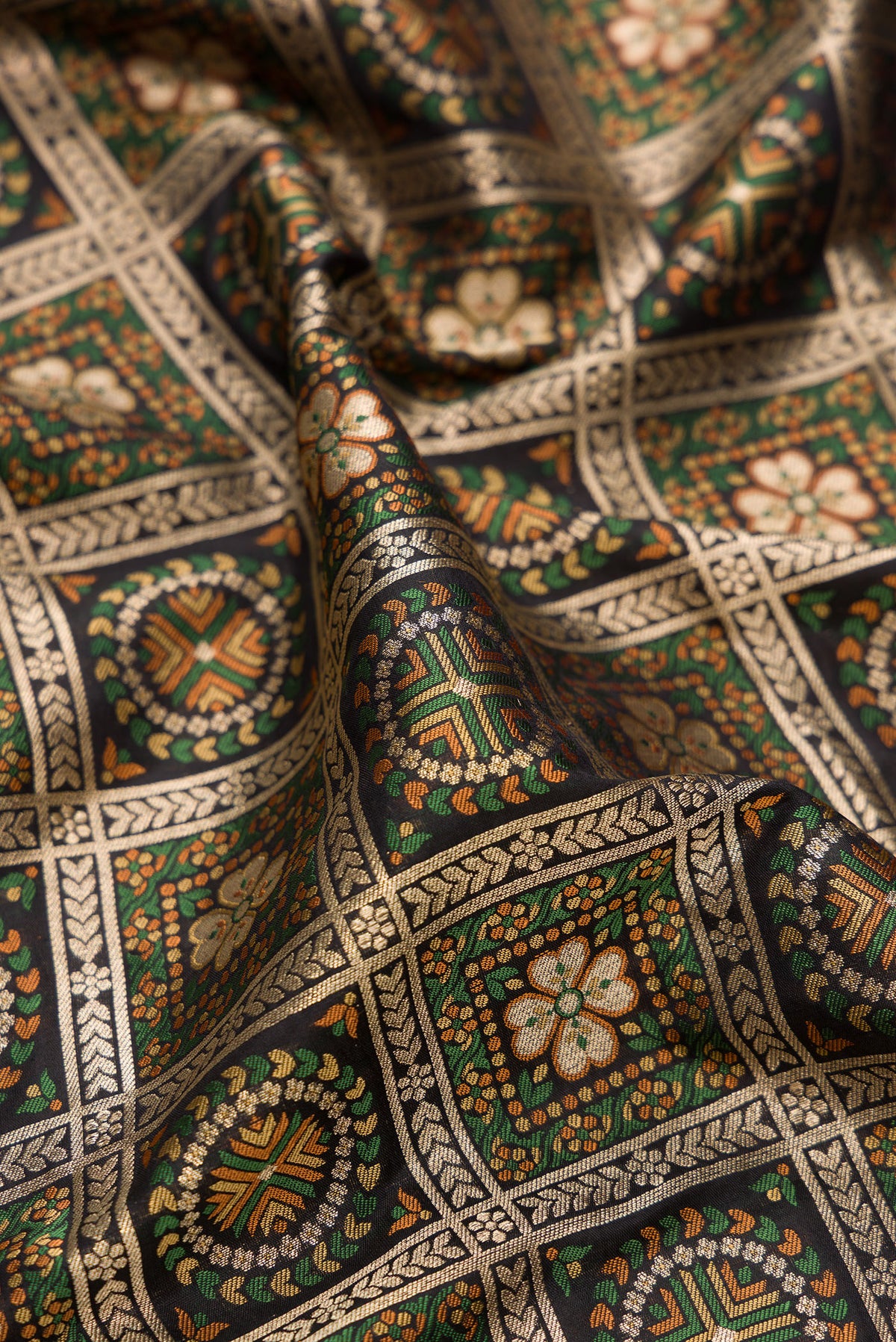 Close up of Pure Silk Black Banarasi Jamavar Saree with Zari Brocade on the body and Fancy Border.  displaying folds