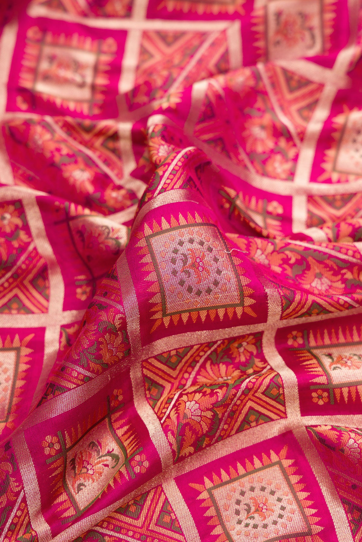 Close up of Pure Silk Dark Pink Banarasi Jamavar Saree with Zari Brocade on the body and Fancy Border.  displaying folds