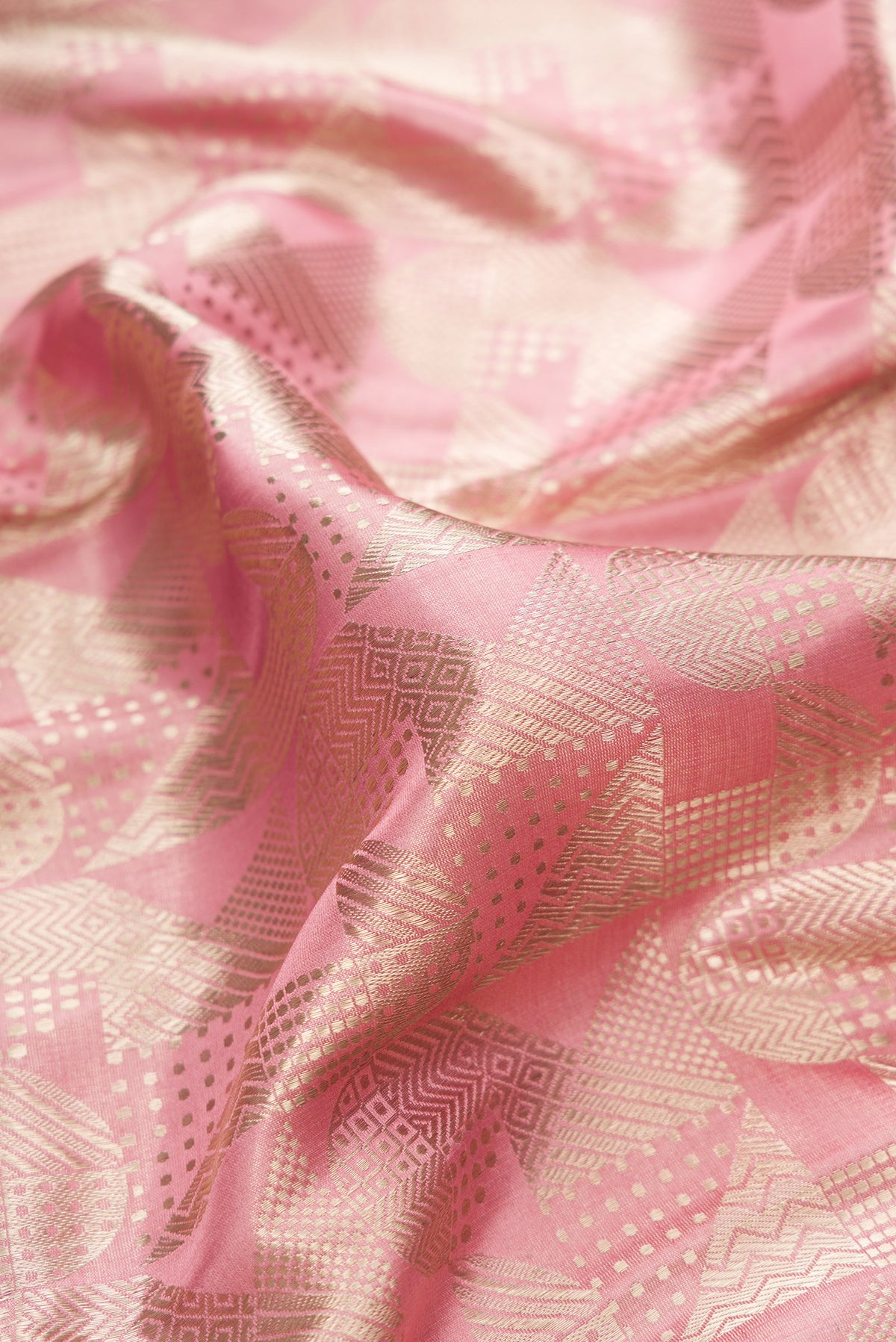 Close up of Pure Silk Rose Gold Dual Tone Banarasi Saree with Zari Brocade on the body and Fancy Border.  displaying folds