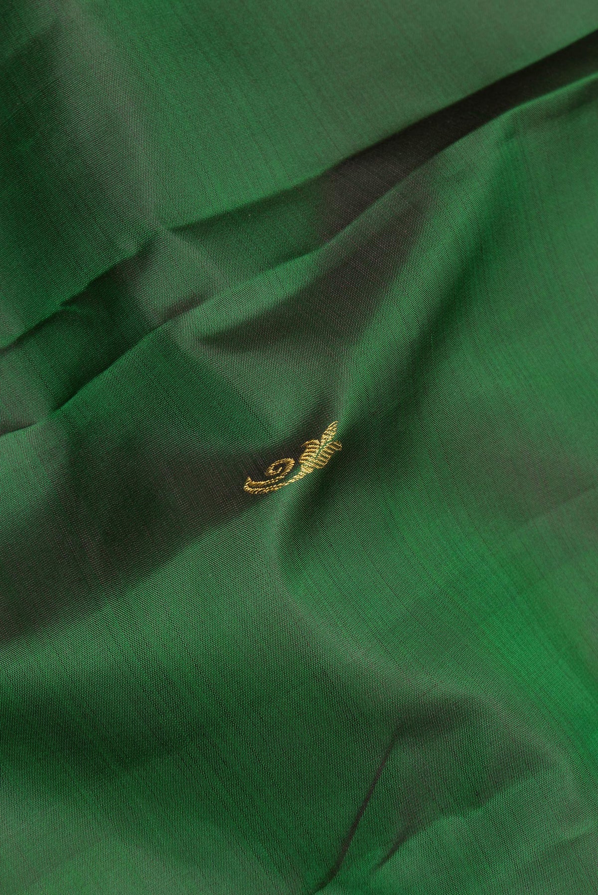 Close up of Pure Silk Green Kanchipuram Saree with Zari Butta on the body and Zari Border.  displaying folds