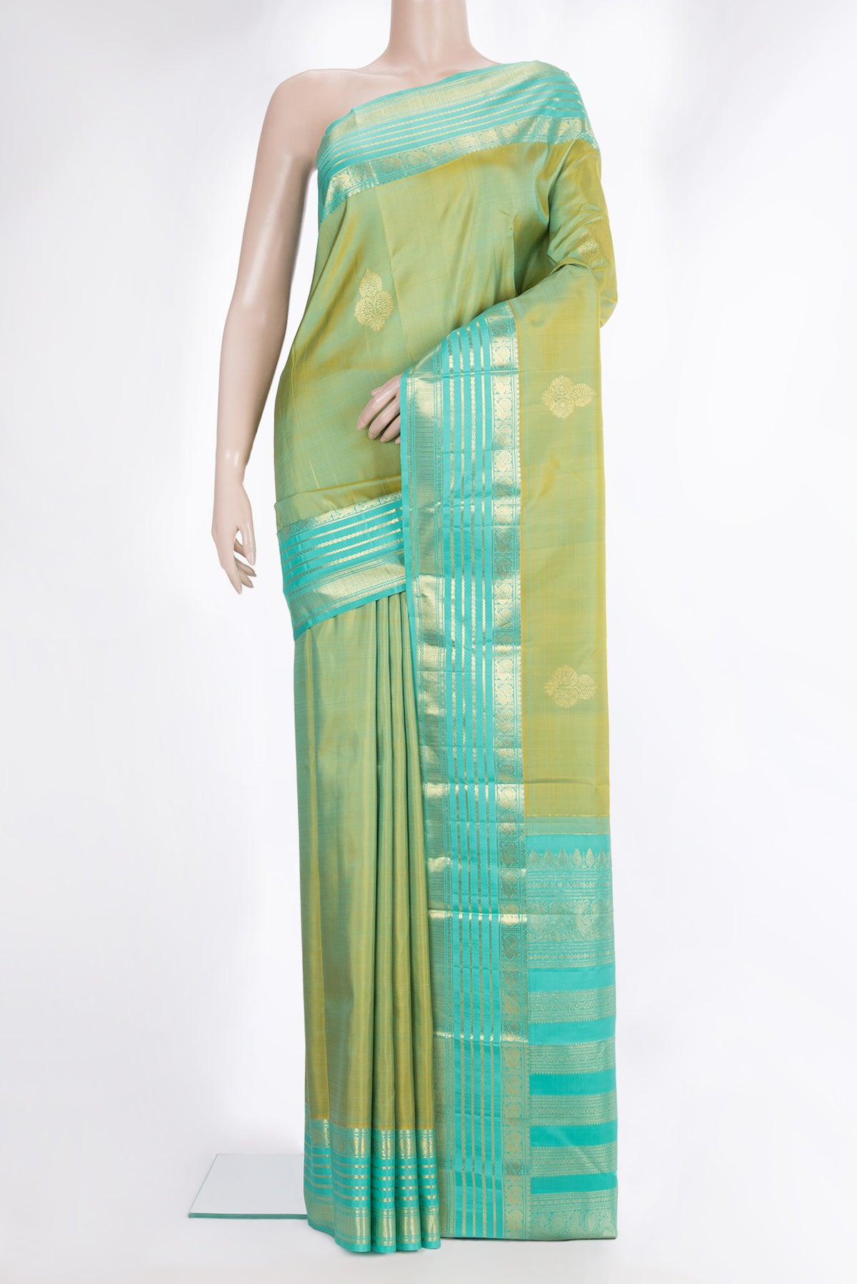 Pure Silk Pista Green Dual Tone Kanchipuram Saree with Zari Butta on the body and Zari Border.  displayed on a mannequin